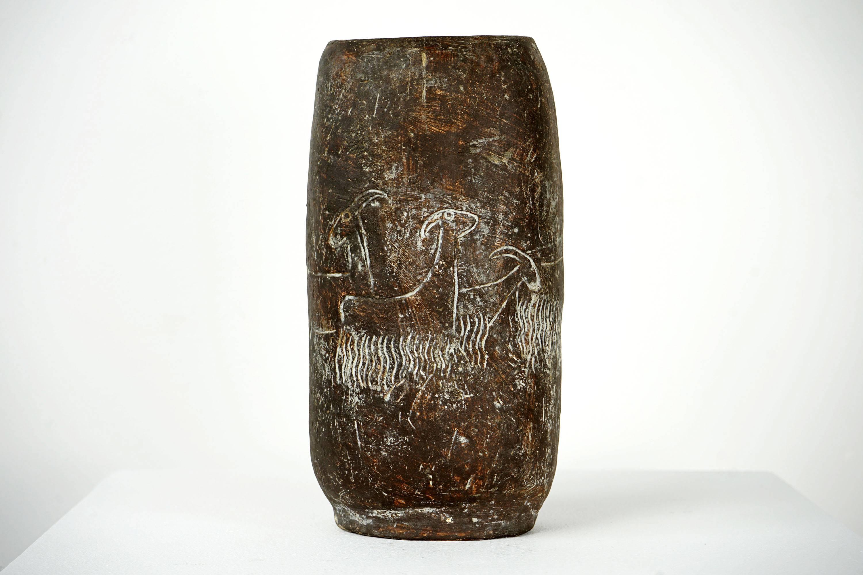 Karen Karnes is a celebrity of pottery. This ceramic vessel was created in the 1960s. The rustic look of the ceramic is complemented by a fine-line motif showing a shepherd and five goats. The surface structure of the vessel is plain on the inside