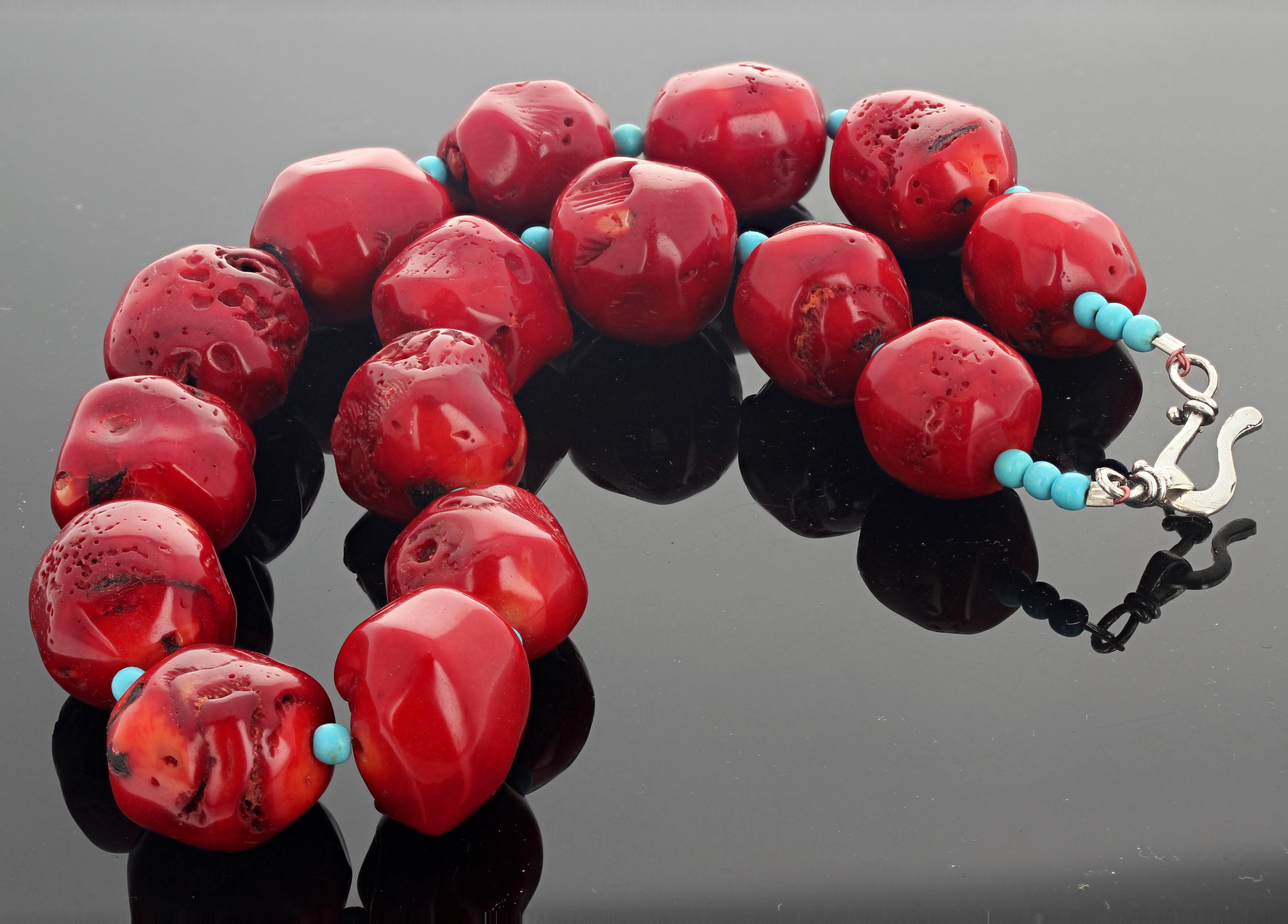 Highly polished chunks of glowing natural red Bamboo Coral accented with little round polished Turquoise set in a 17 inch long necklace with silver hook clasp.  