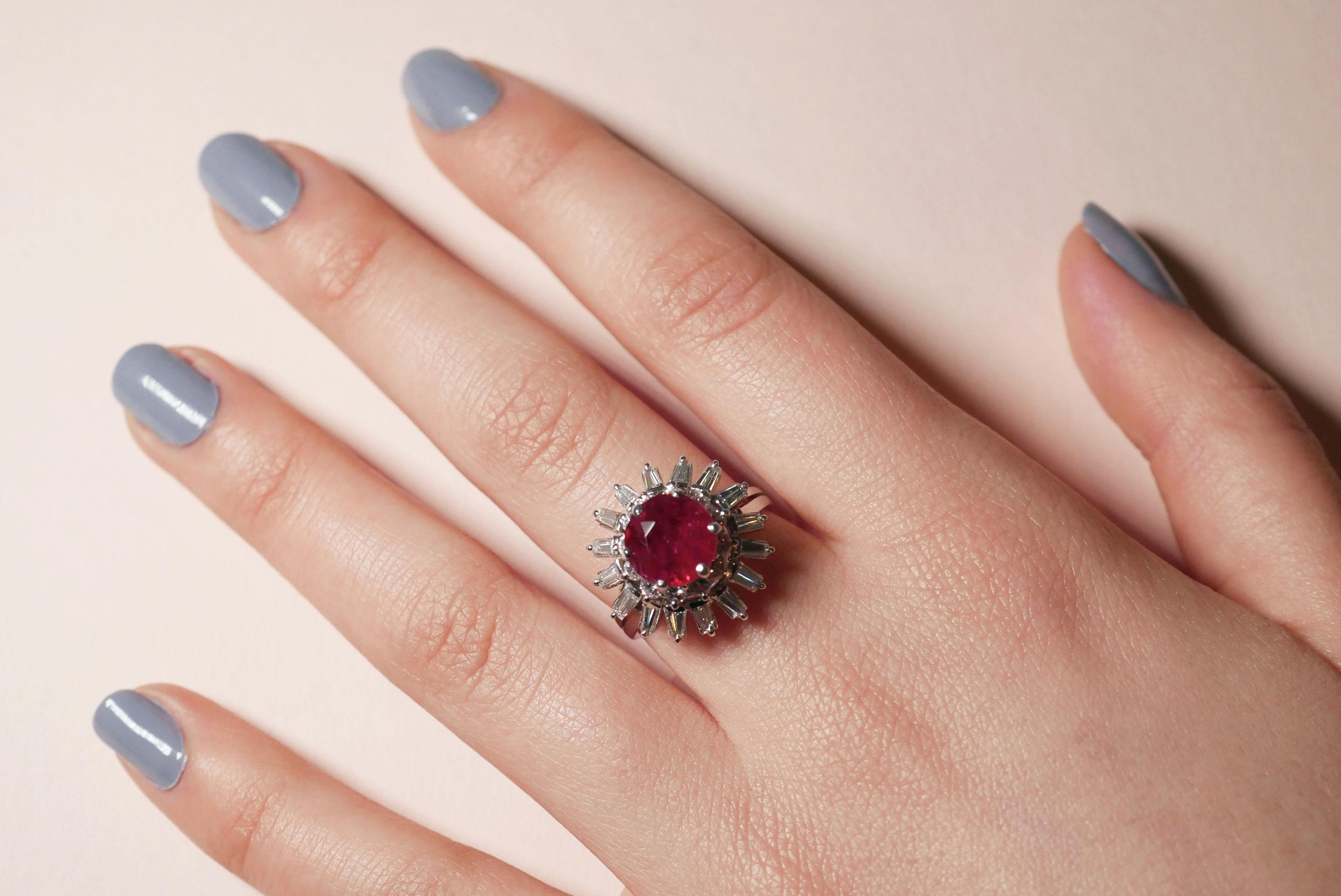 Designed and crafted by the Haruni family, this statement ring makes the classic combination of rubies and diamonds that little bit more interesting. The centre stone is a round ruby in vivid red, brought to life by a unique white diamond baguette