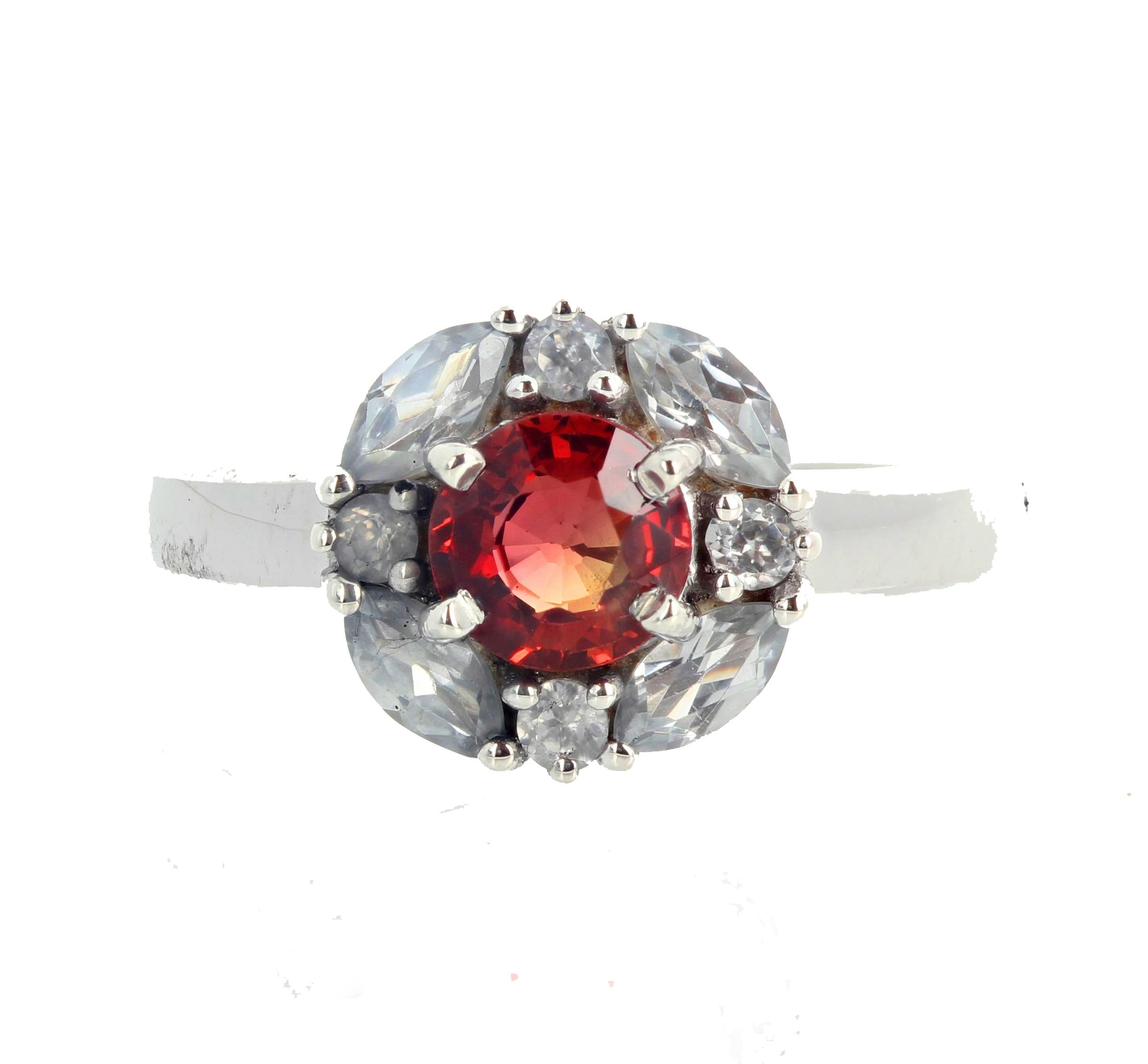 Unique 6 mm round sparkling rare red Sapphire (0.94 Carat) set in a rhodium plated sterling silver ring enhanced with natural sparkling real white Cambodian zircons.  The ring is a size 7 (sizable for free).  This is truly magnificent.