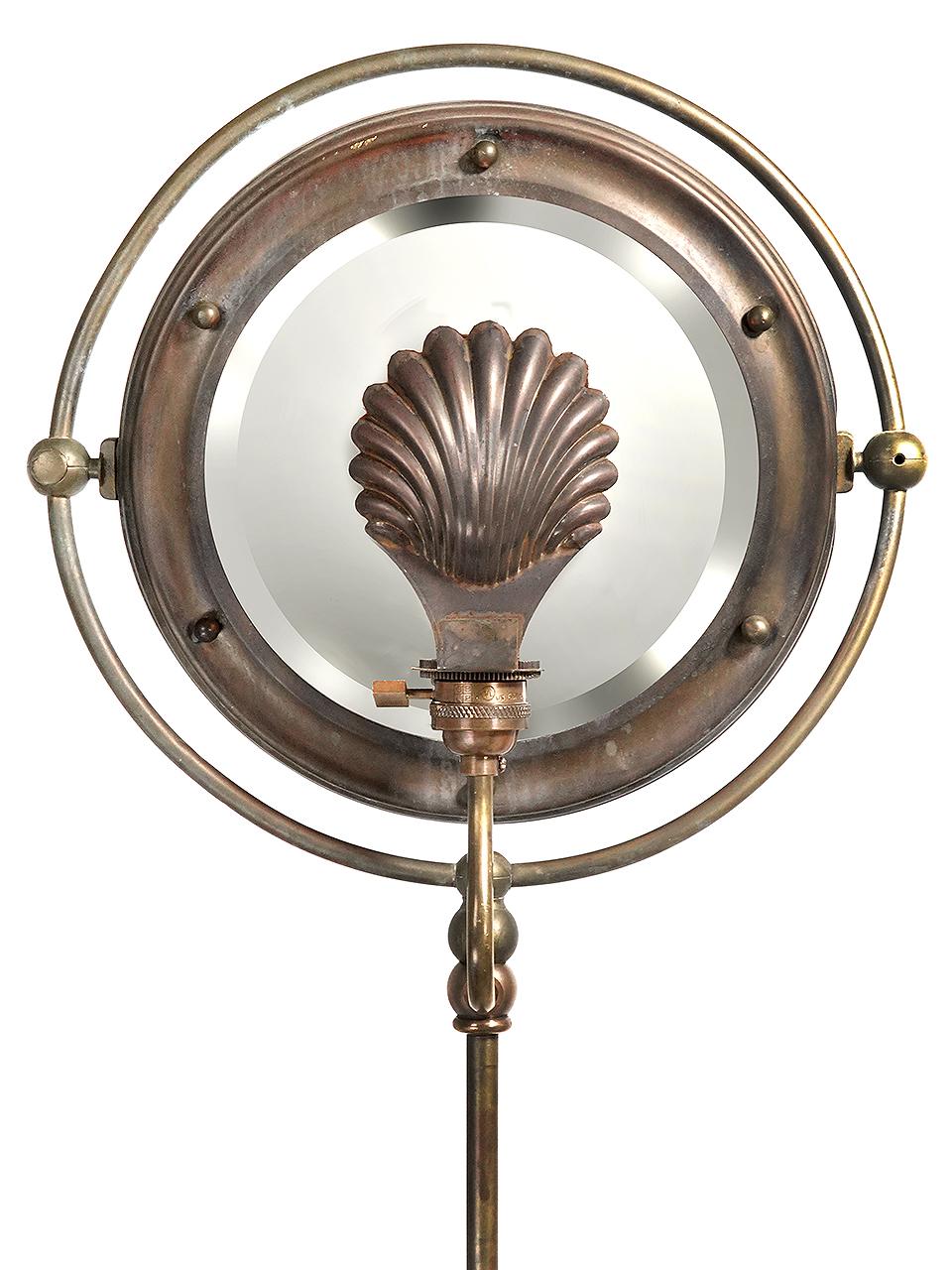 From the porthole mirror frame to the fish head feet plus a brass seashell shade this standing lamp is unique as they come. The look is both quirky and highly elegant at the same time. A very tough thing to balance. The round mirror has a one inch