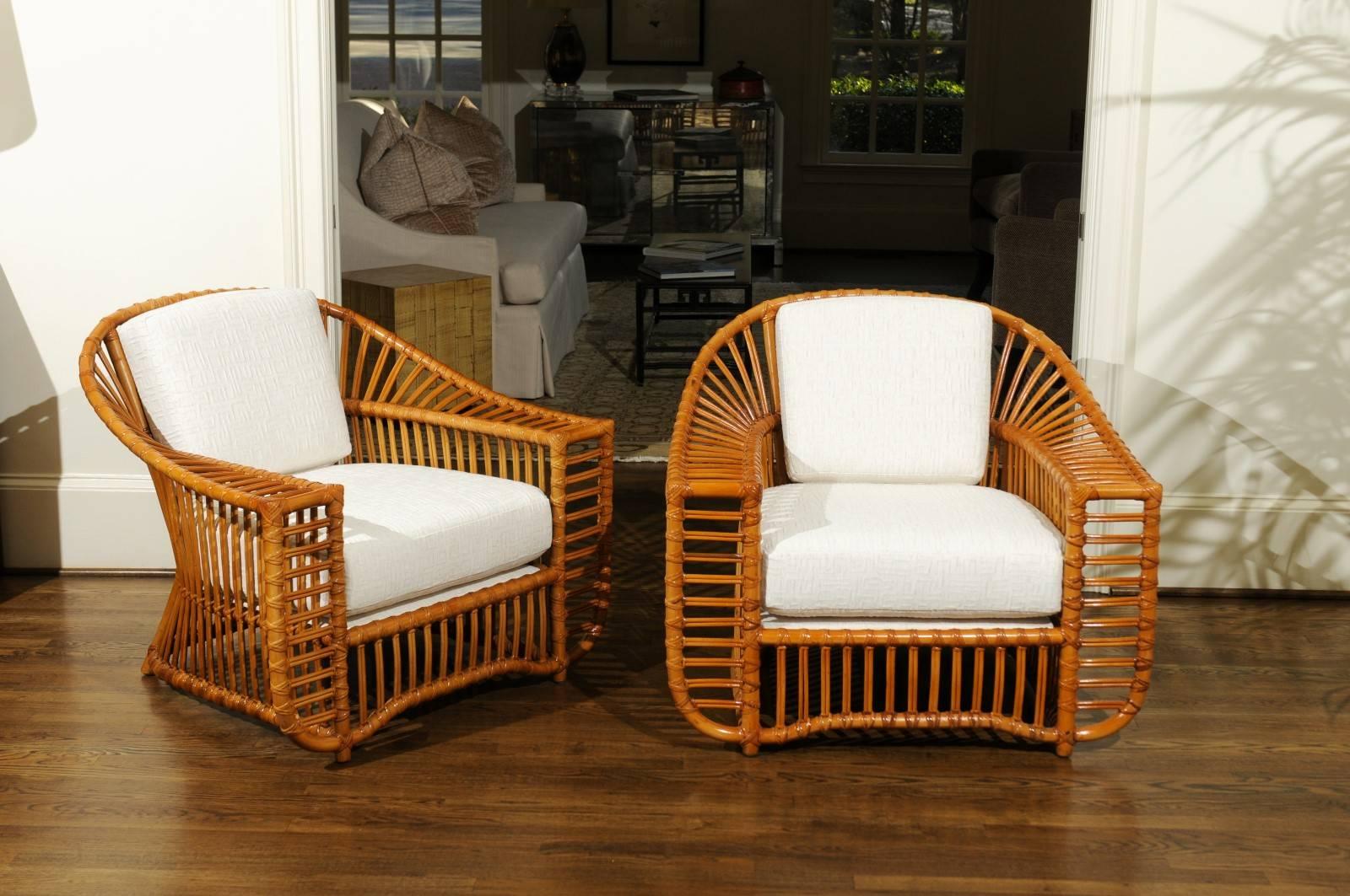 An exquisite and unique pair of lounge or club chairs by the esteemed Henry Olko for his Willow and Reed firm, circa 1979. These rare chairs are from the Tiara series. Stout and sturdy rattan and hardwood construction with exacting detail. These