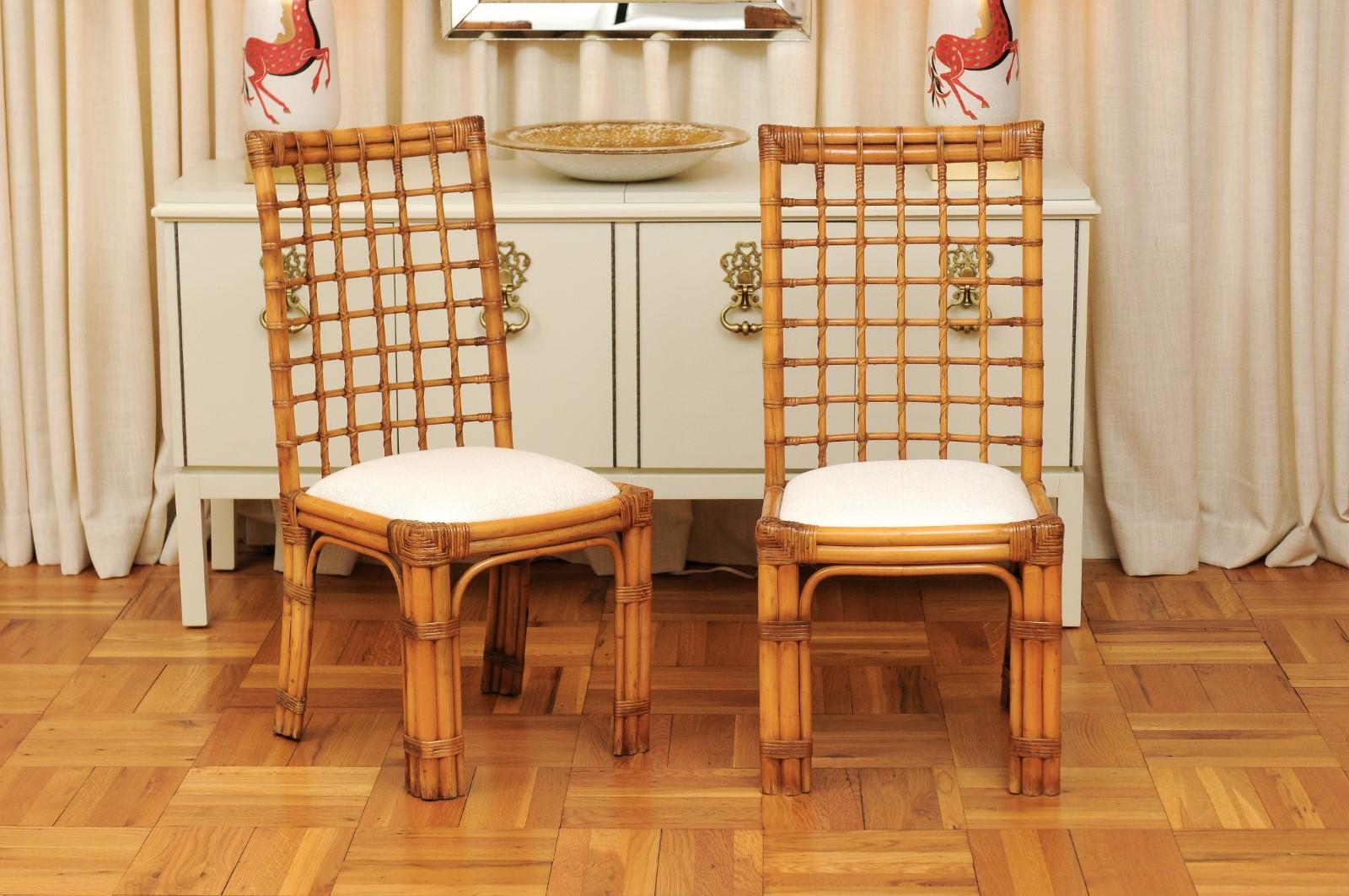 An exquisite and unique set of eight (8) high-back dining chairs by the esteemed Henry Olko for his Willow and Reed firm, circa 1979. These rare chairs are from the Olko's Square series. Stout and sturdy rattan and hardwood construction with