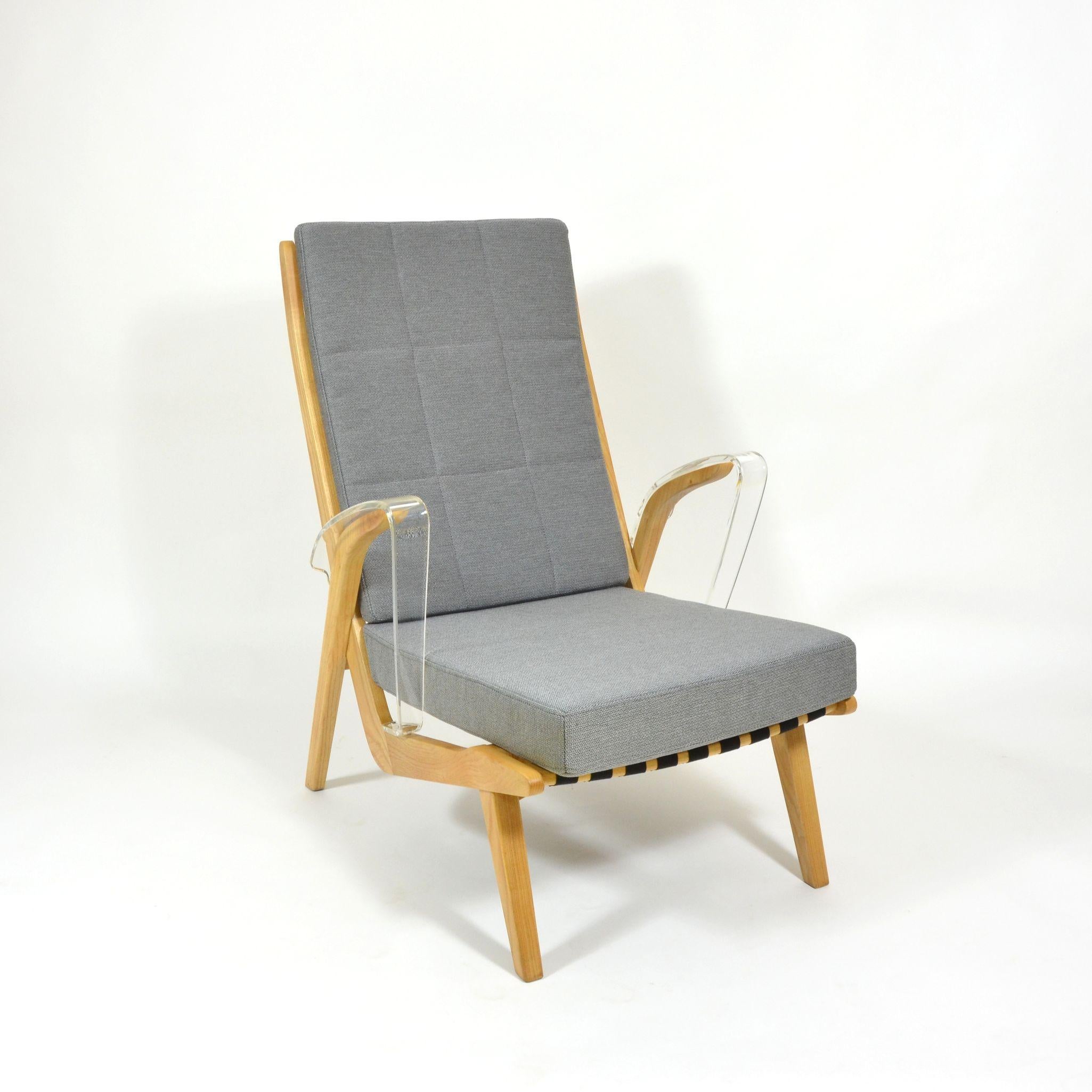 Rare model of armchair with removable upholstery pillows. Armchair has wooden construction from beech wood. Seat is made from black strap and new upholstery is covered by grey upholstery fabric with precise details. The most unique part are armrests