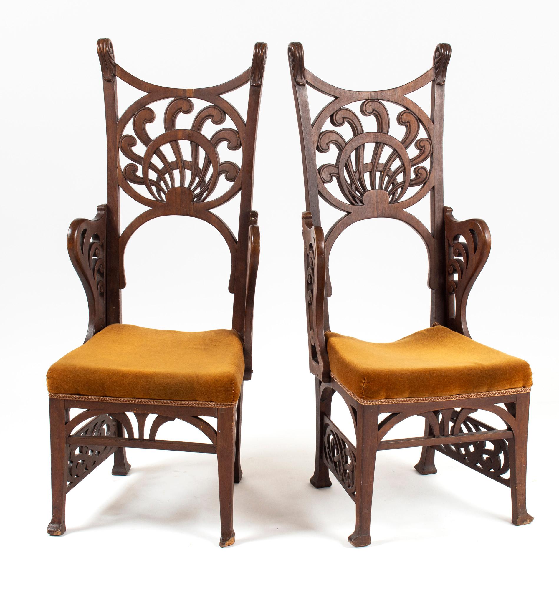Four unique chairs in art nouveau style with carved walnut decor. The carved forms let the chairs be dated back to the 1900s artistic movements. The prolonged and sophisticated shapes, typical for the period, manifest the ideology of