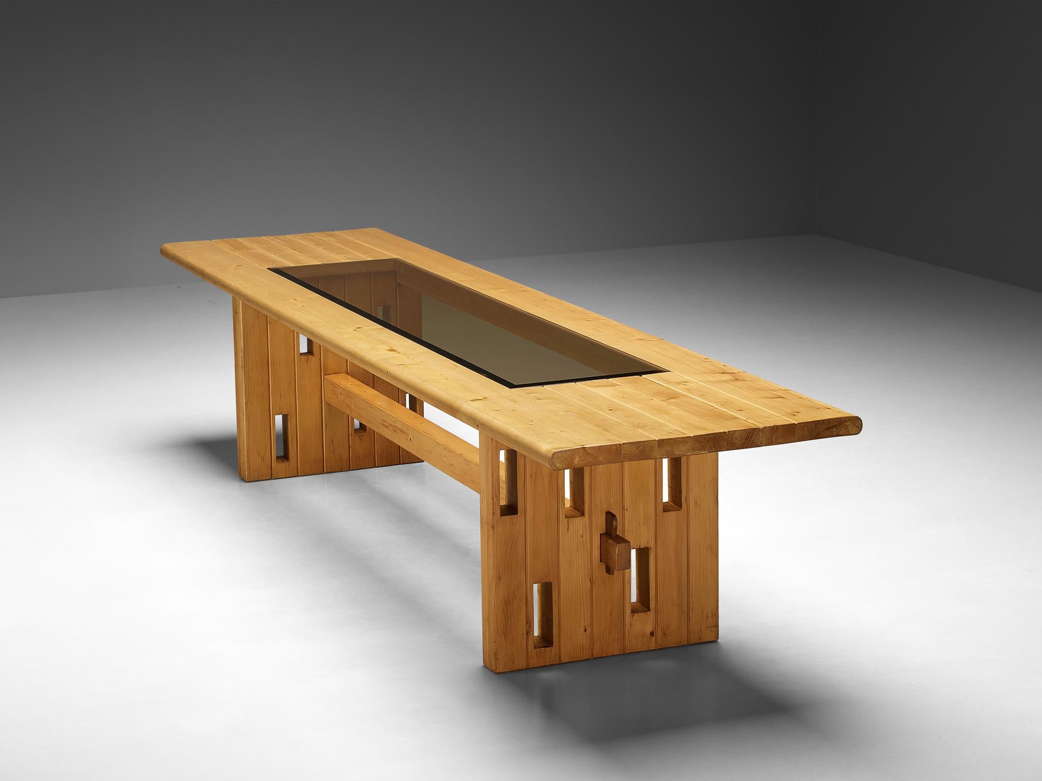 Dining table, solid pine, smoked glass, Italy, 1970s

The artisan demonstrates its remarkable ability to embody material and technical expertise through this table, setting a prime example. Constructed from premium pinewood, the table's sturdy