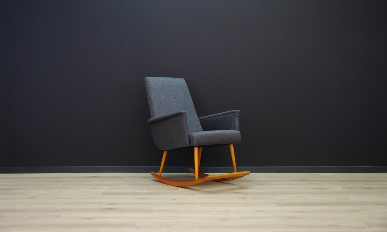 Unique rocking chair, Danish design of the 1970s. Sensational form, covered with a new fabric (color-graphite), construction made of teak. The armchair is in good condition (small upholstery and scratches), directly for use.

Dimensions: Height