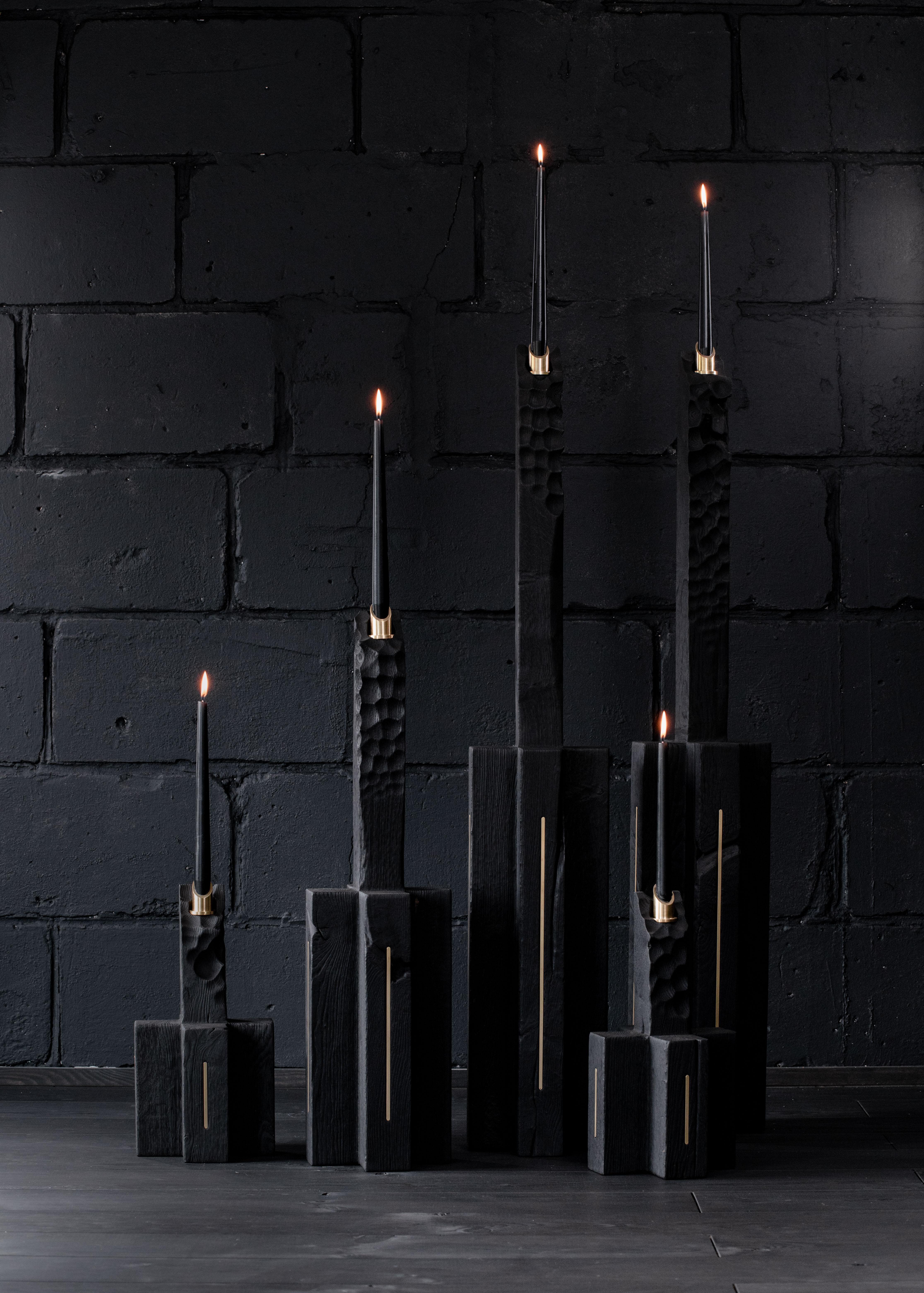 Unique roots candle large by Jeremy Descamps
Unique piece
Dimensions: 20 x 20 x 120 cm
Materials: candles in solid oak from the country burned in flam, inserts in brass, support of candles in brass.

Even in the darkest places, where everything
