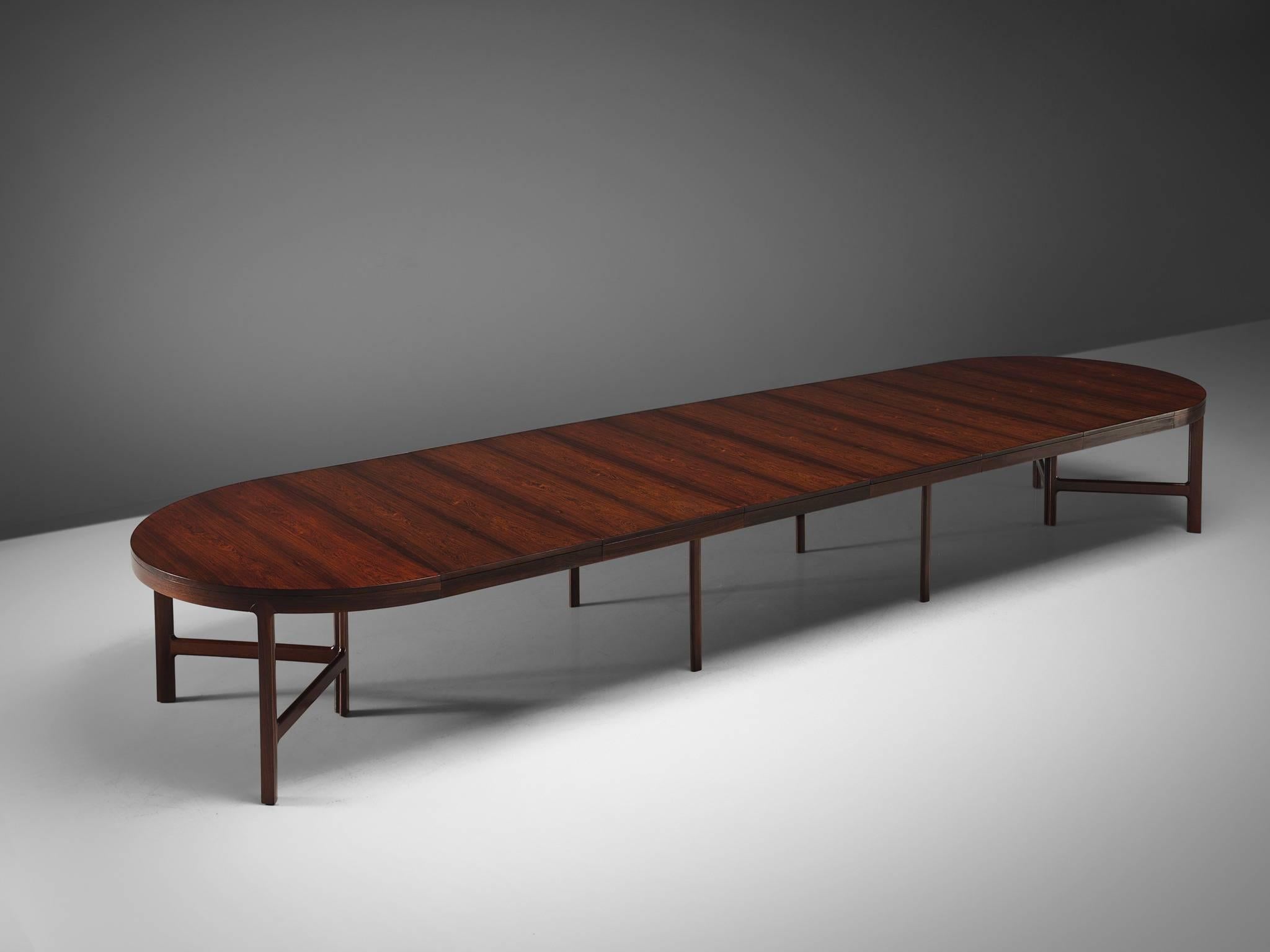 Danish cabinet maker, rosewood, Denmark, 1960s

Very large oval dining table with two tripod legs on each side and four legs in the middle. The grain of the rosewood and the exceptional length make this into a luxurious, probably custom-made