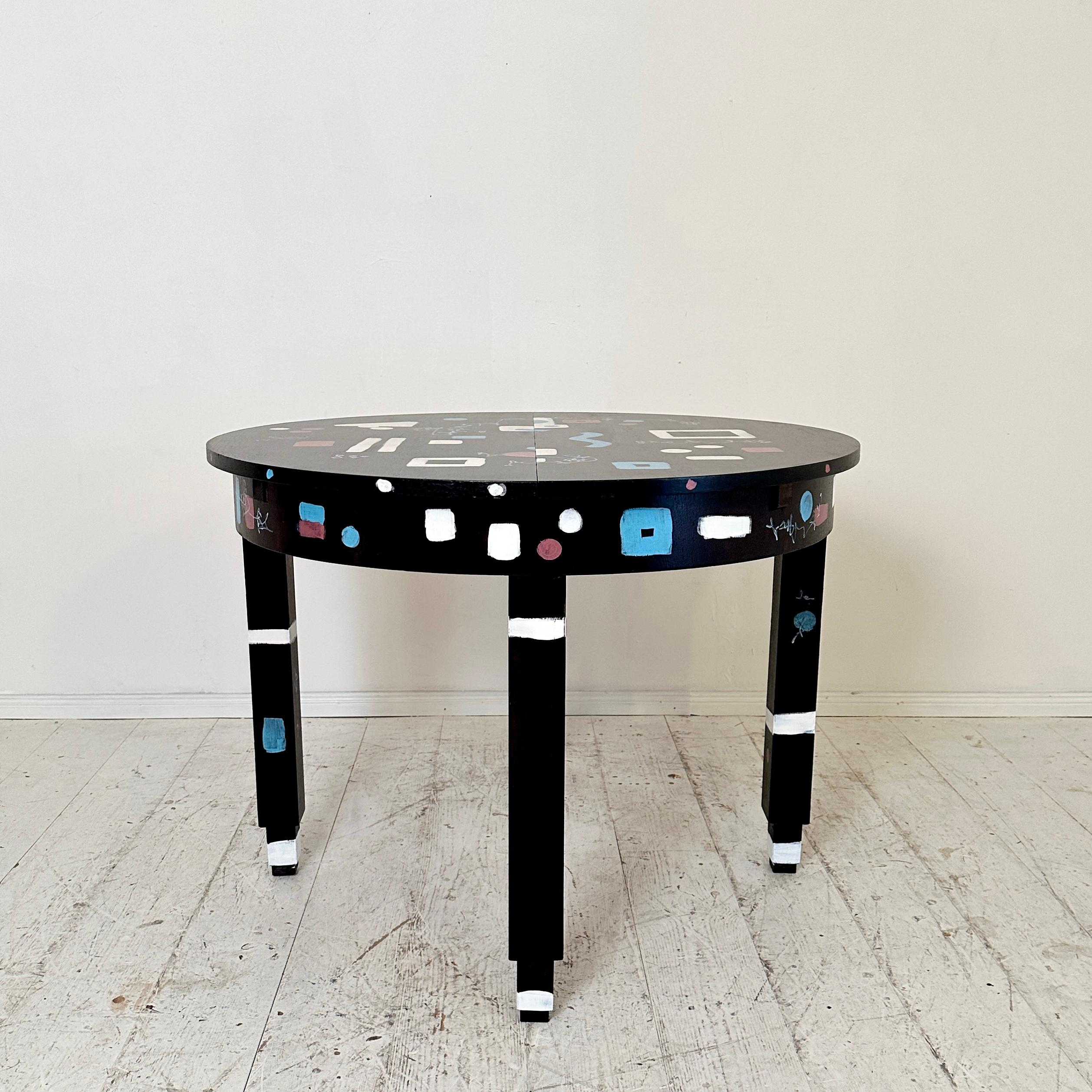 
This unique 1920 round extendable Bauhaus table beautifully exemplifies the innovative spirit of the Bauhaus movement, blending functionality with modern aesthetics. Recently re-painted, the table features a striking black base color contrasted by