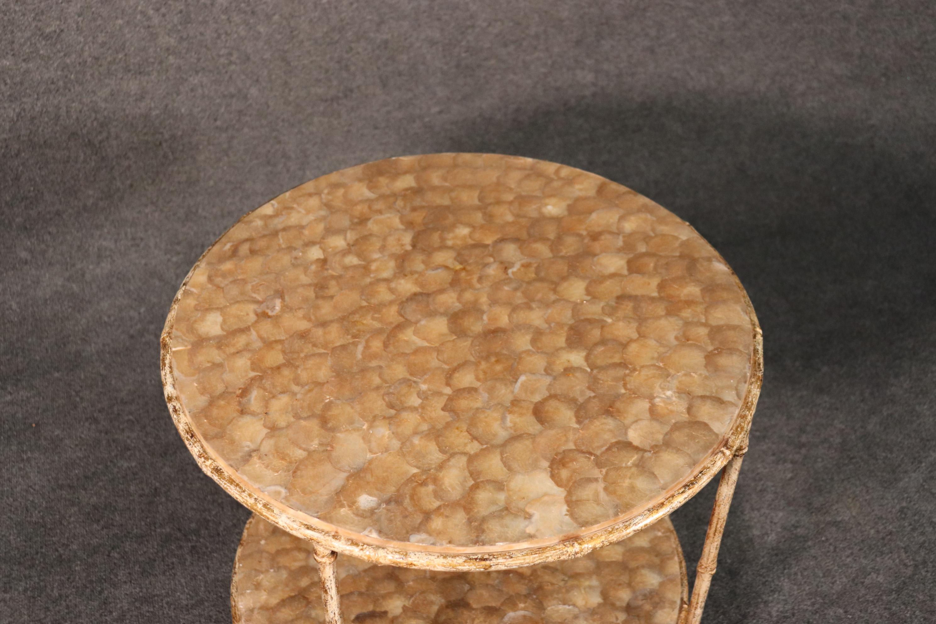 This is a beautiful capiz shell end table with two tiers for additional utility, circa 1960. The table is French and dates to the 1960s. The table measures 24 wide x 24 deep x 25 tall.