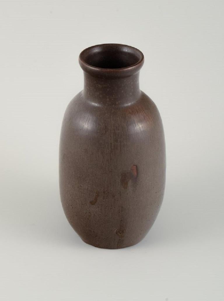Unique Royal Copenhagen ceramic vase by Carl Halier / Patrick Nordstrøm.
Beautiful glaze in shades of brown.
Dated 1937
First factory quality.
In perfect condition. 
Height 20 cm. Diameter: 11 cm.