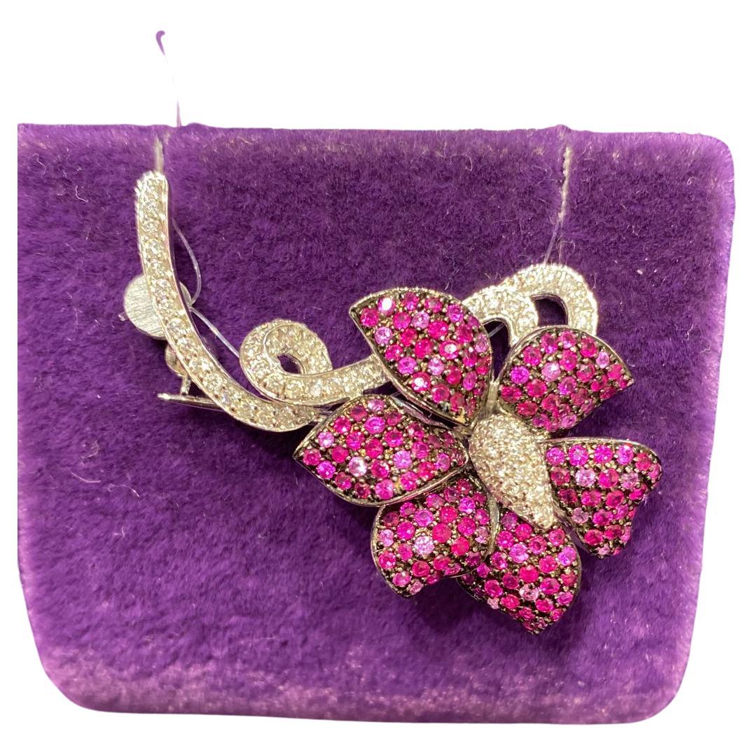 Brooch White Gold 14K
Diamond 66-RND-0,43-G/SI3A
Pink Sapphire 49--RND-0,44 2/1C 
Ruby 106-RND-0,86 Т(5)/4C  
Weight 5,62 grams

With a heritage of ancient fine Swiss jewelry traditions, NATKINA is a Geneva-based jewelry brand that creates modern