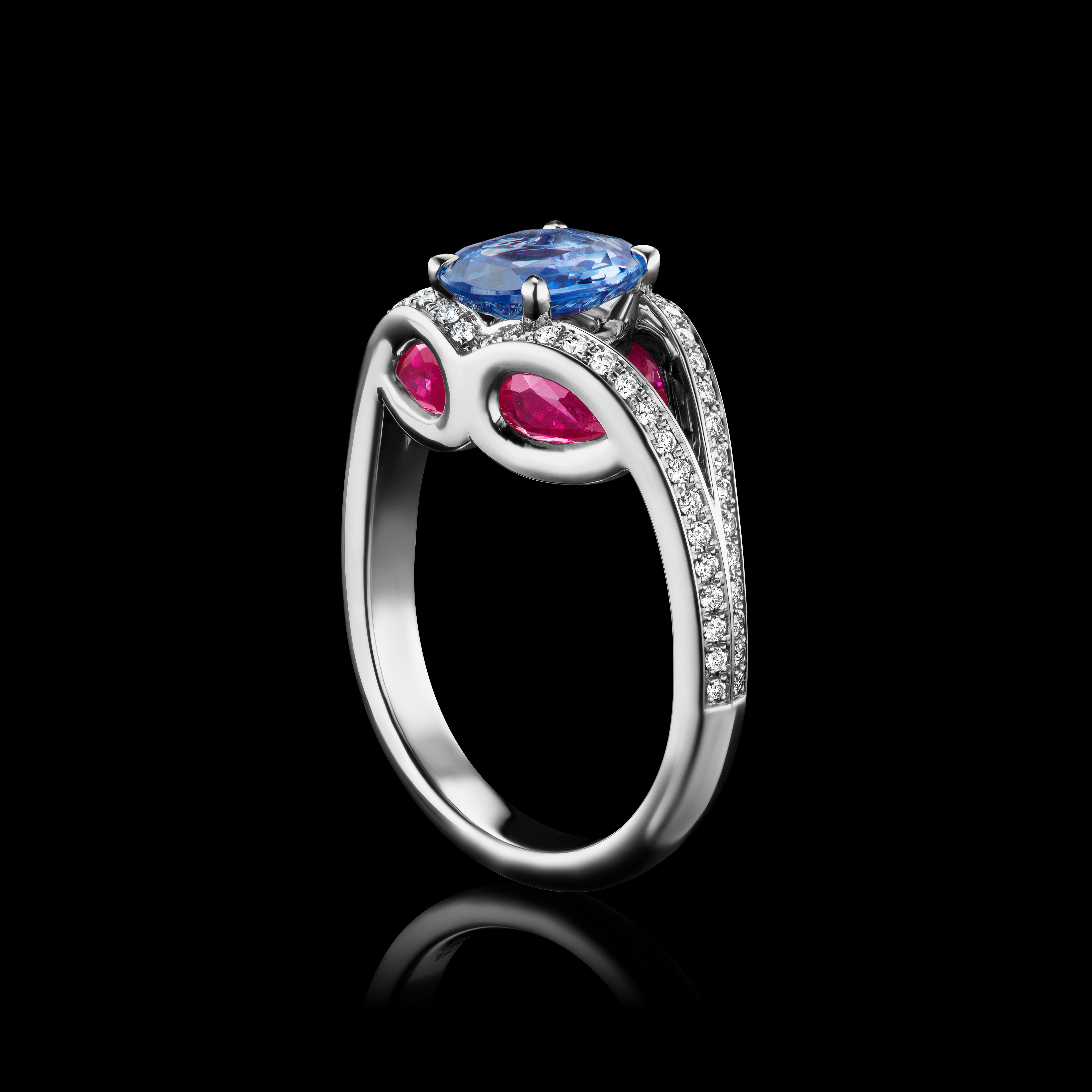 An interesting ring that has a Sapphire which you can see thru the Tourmaline and Ruby at 3 carats of gemstones and the band has 64 diamonds surrounding it all set in Platinum. 

