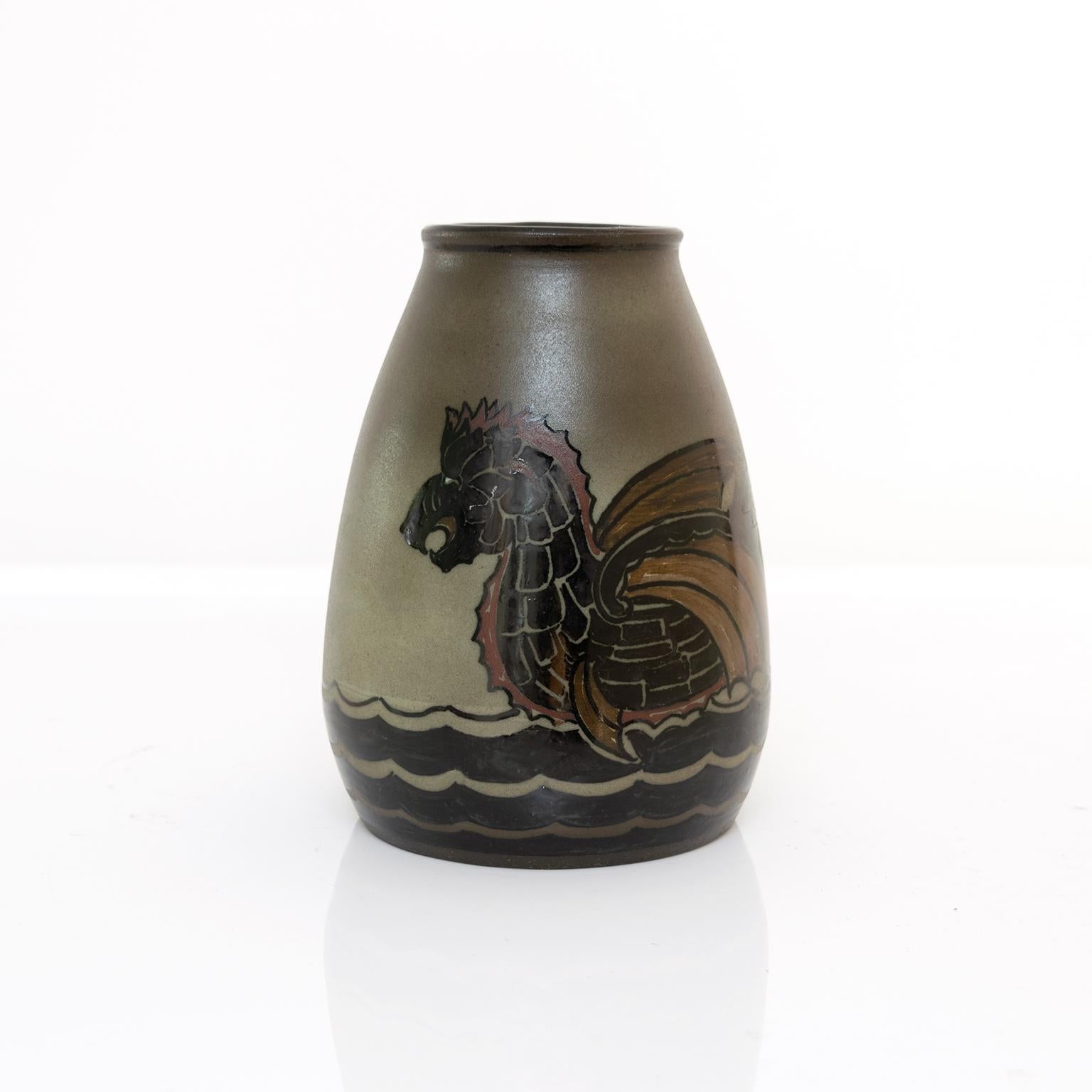 Unique Scandinavian Modern hand thrown and painted ceramic vase by Josef Ekberg for Gustavsberg, Sweden. The vase depicts a boat carved as a serpents body at sea. Circa 1930.

Measures: Height: 7.75