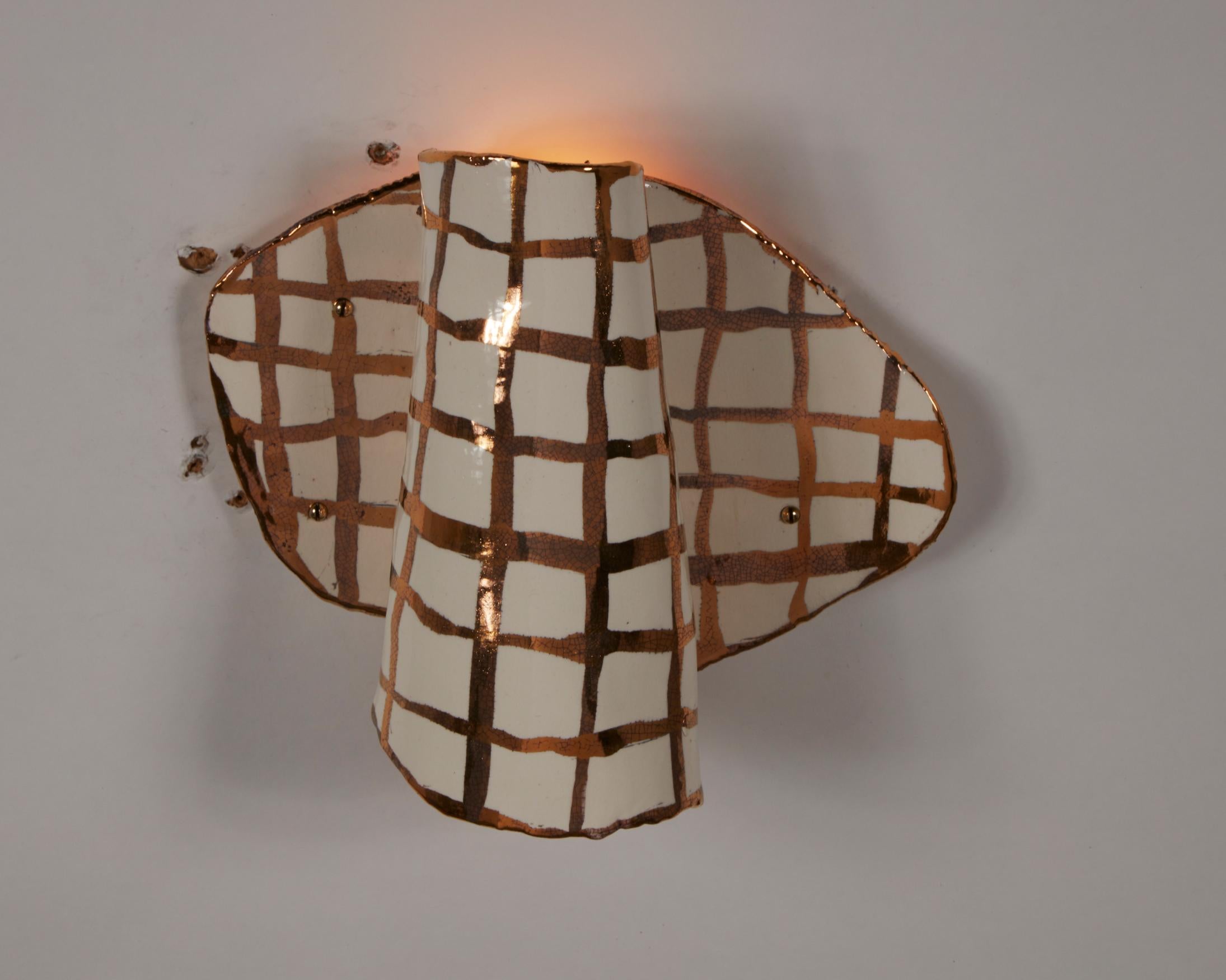 Unique sconce in white and gold glazed porcelain. Designed and made by Katie Stout, USA, 2019.
