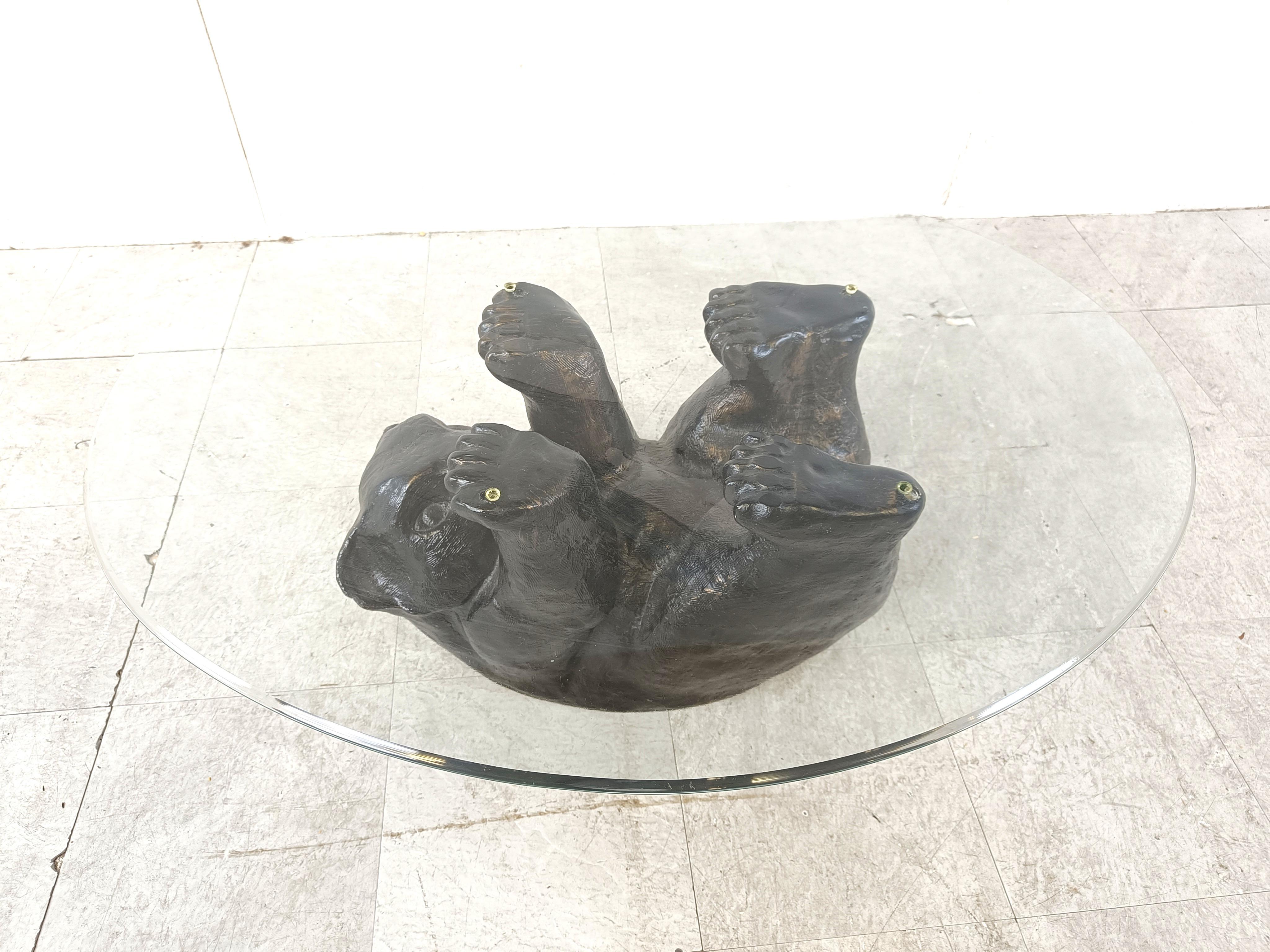 Eye-catching sculptural black bear coffee table.

This unique table looks great and somewhat cute.

1970s - Belgium

Good condition

Dimensions base:
Height: 40cm
Width: 90cm
Depth: 70cm

Ref.: 385192