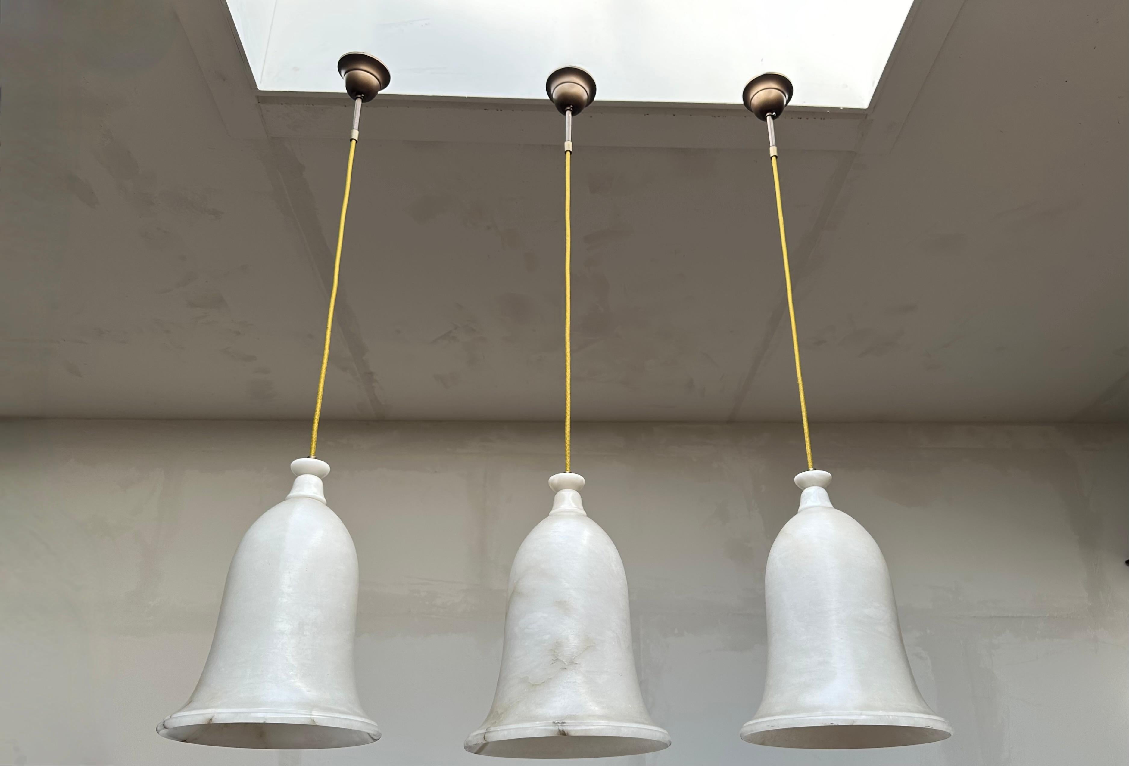 Large size and great shape group of three identical alabaster pendants.

If you are looking for a group of beautiful and truly stylish pendants for a midcentury, for an Art Deco or for a contemporary interior then this set of three could be your