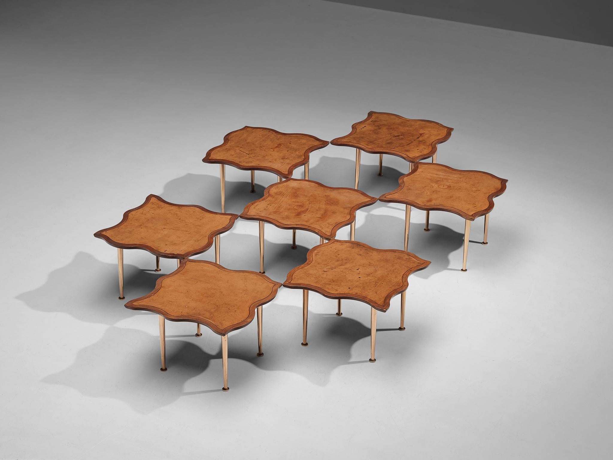 Side tables, pine, leather, copper anodized metal, France, 1960s. 
 
This extraordinary set of side tables features a remarkable biomorphic tabletop, and due to its shape this set fits together like one large puzzle. Therefore, the possibilities