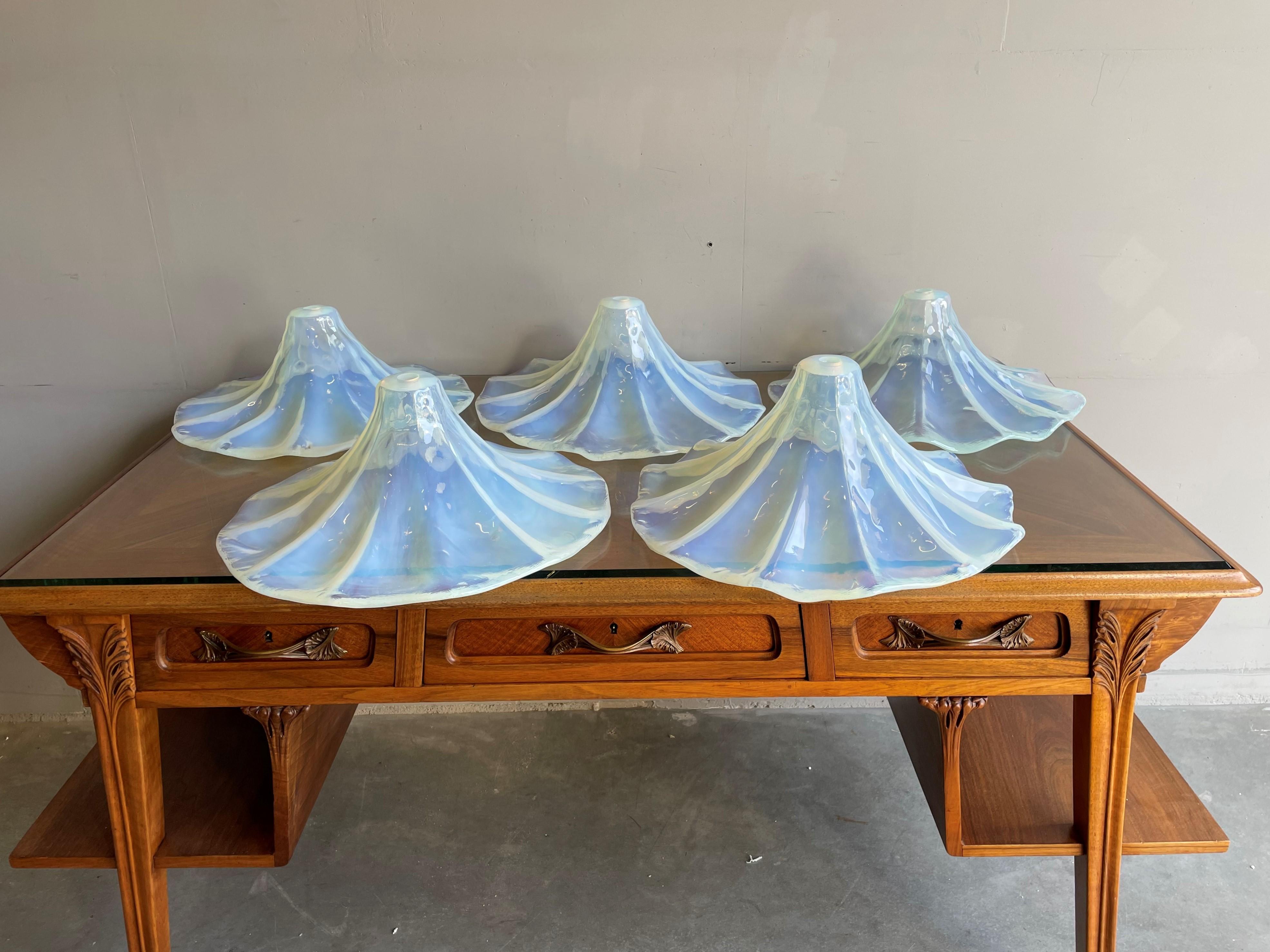 Good size and great shape group of five / 5 midcentury pendant shades.

About eight years ago we purchased this amazing design and superb condition set of five midcentury, art glass shades from the man who said he had salvaged them from a