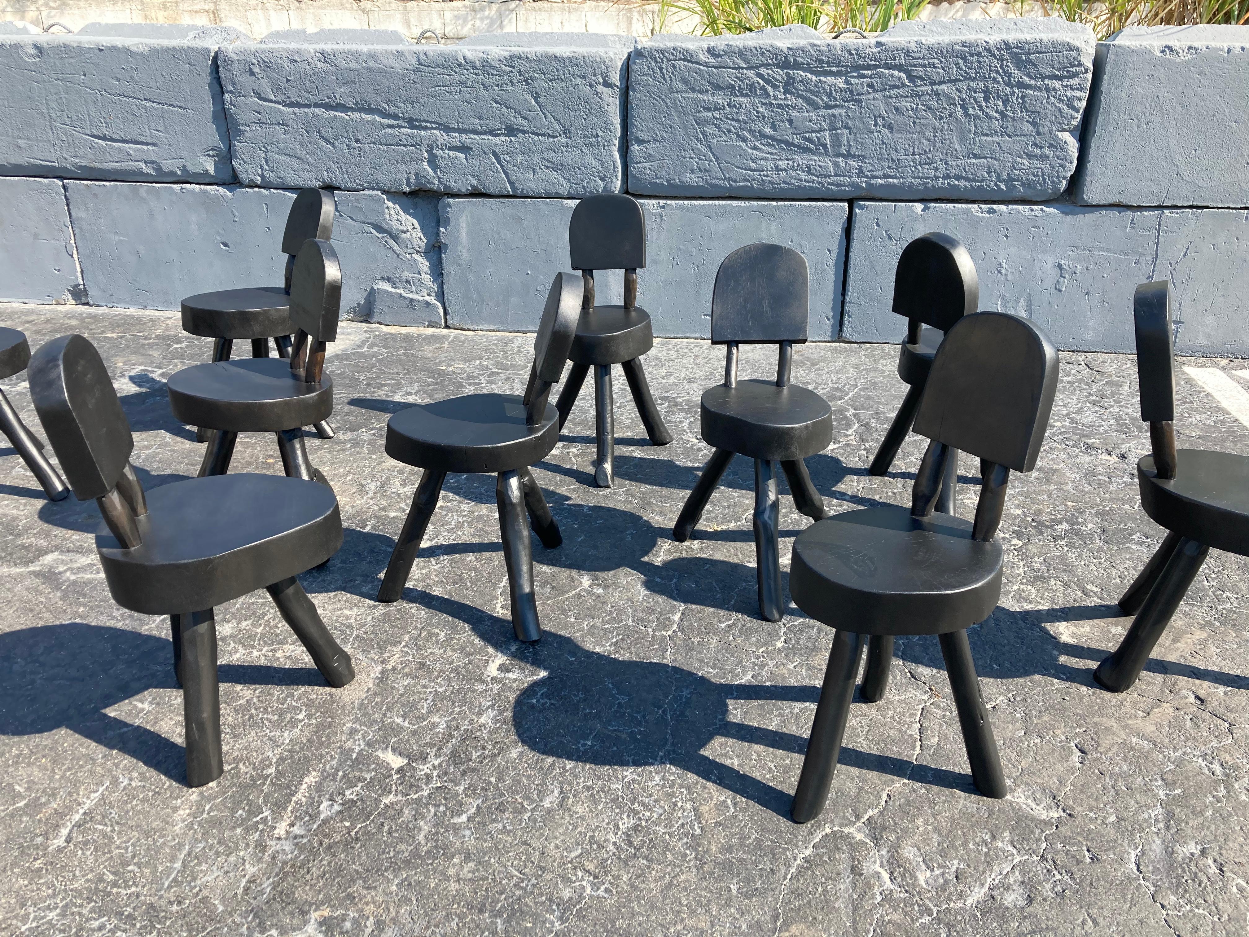 Set of ten tree dining chairs in black.