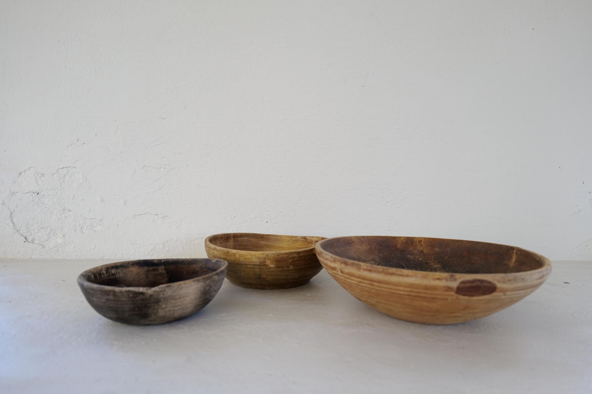 Set of 3 antique and unique three sizes organic wooden bowls. With highly appealing patina, with traces of use. Produced in Sweden, 19th century. 
These bowls where very important for many families; therefore, they were passed on from generations.