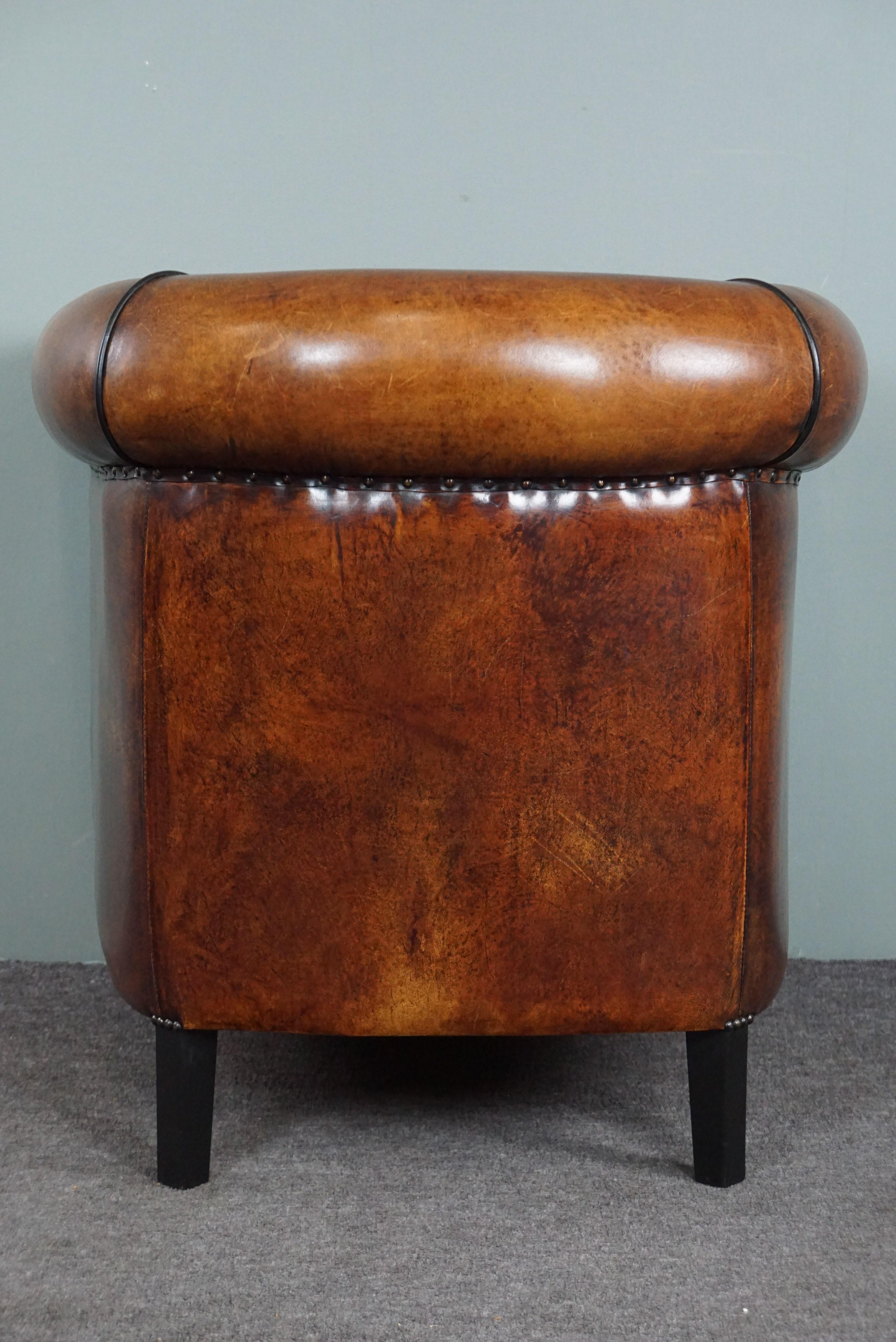 Hand-Crafted Unique sheep leather club chair with black piping and decorative nails For Sale