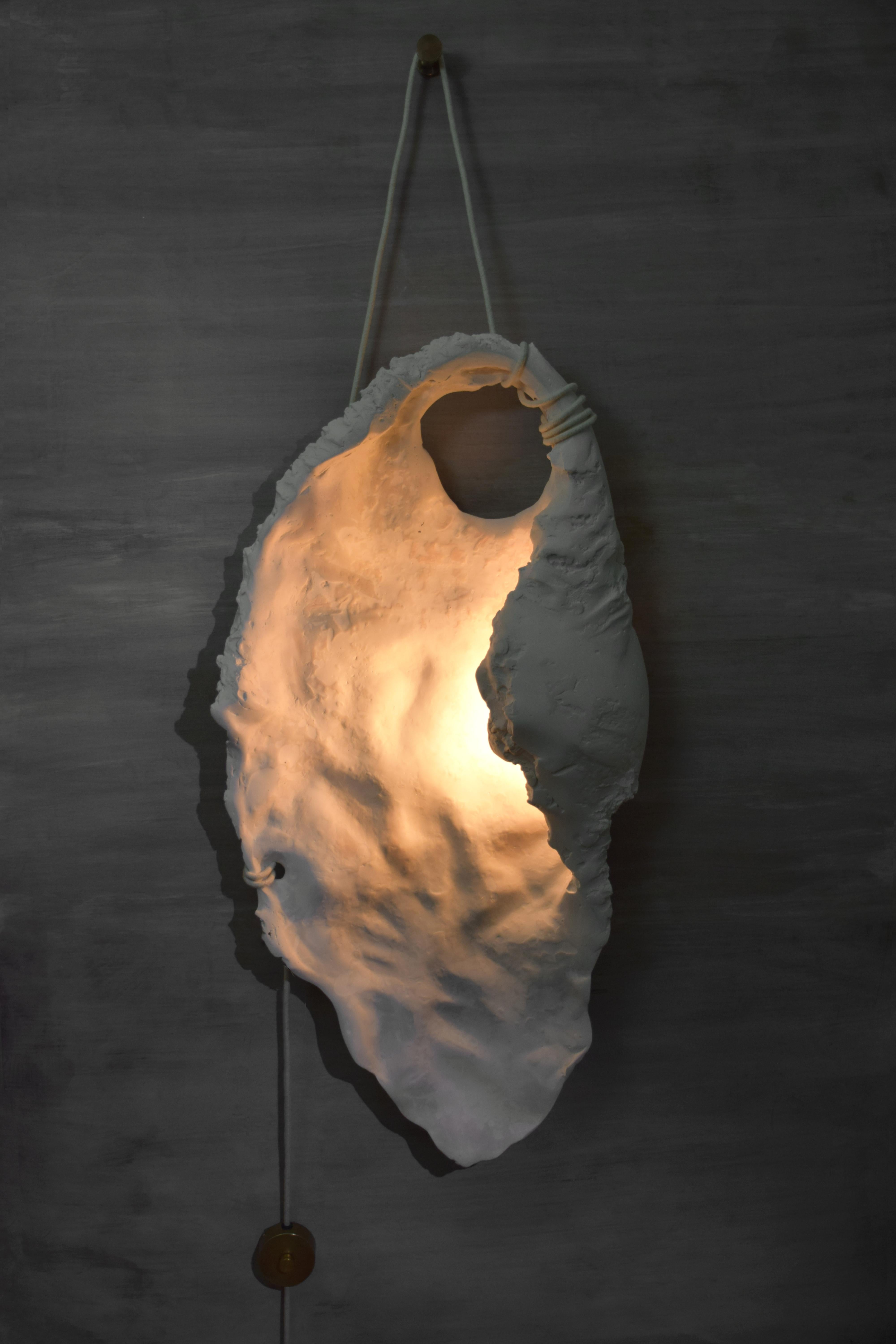 Unique shell light wall sculpture III by Isac Elam Kaid
Unique 
Dimensions: W 53 x D 18 x H 102 cm.
Materials: Gypsum, Stone powder, Wax finish, Linen wrapped cord, patinated brass.

All our lamps can be wired according to each country. If sold