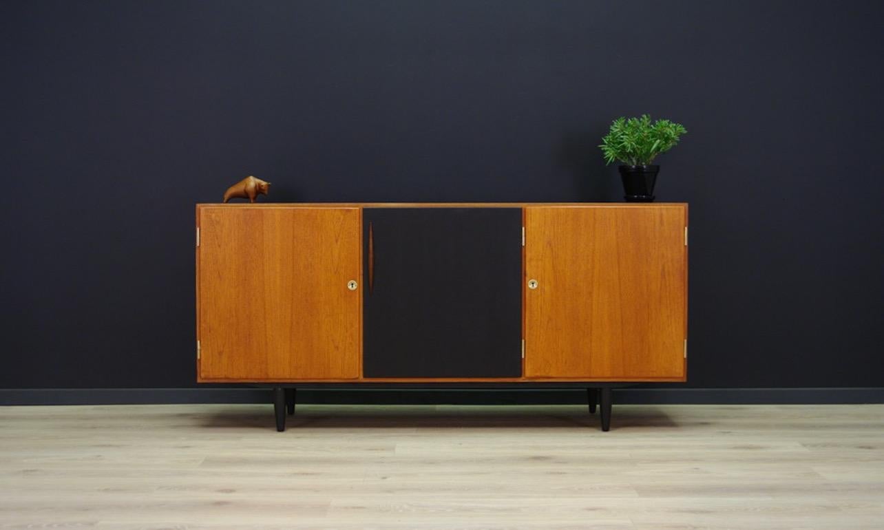 Unique sideboard from the 1960s, a minimalistic form finished with teak veneer. Roomy interior with shelves behind the doors. Table and middle door painted with black paint. Preserved in good condition (small dings and scratches), directly for