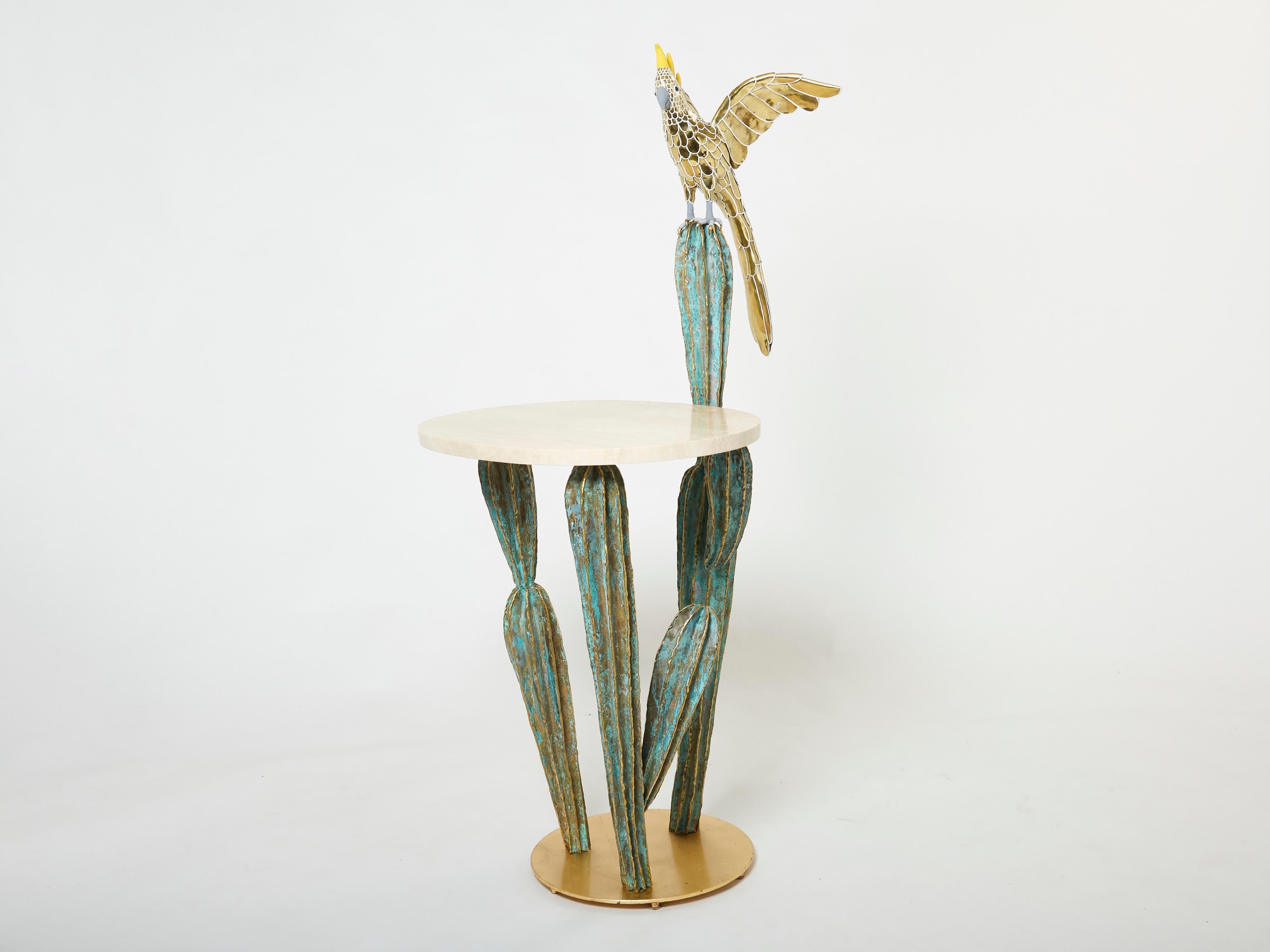 This unique cactus and parrot sculpture console table signed Alain Chervet is made of solid gilded and oxidized brass, and dated 1989. It features an oval slick travertine top. The console base is made of brushed brass, supporting a beautiful green
