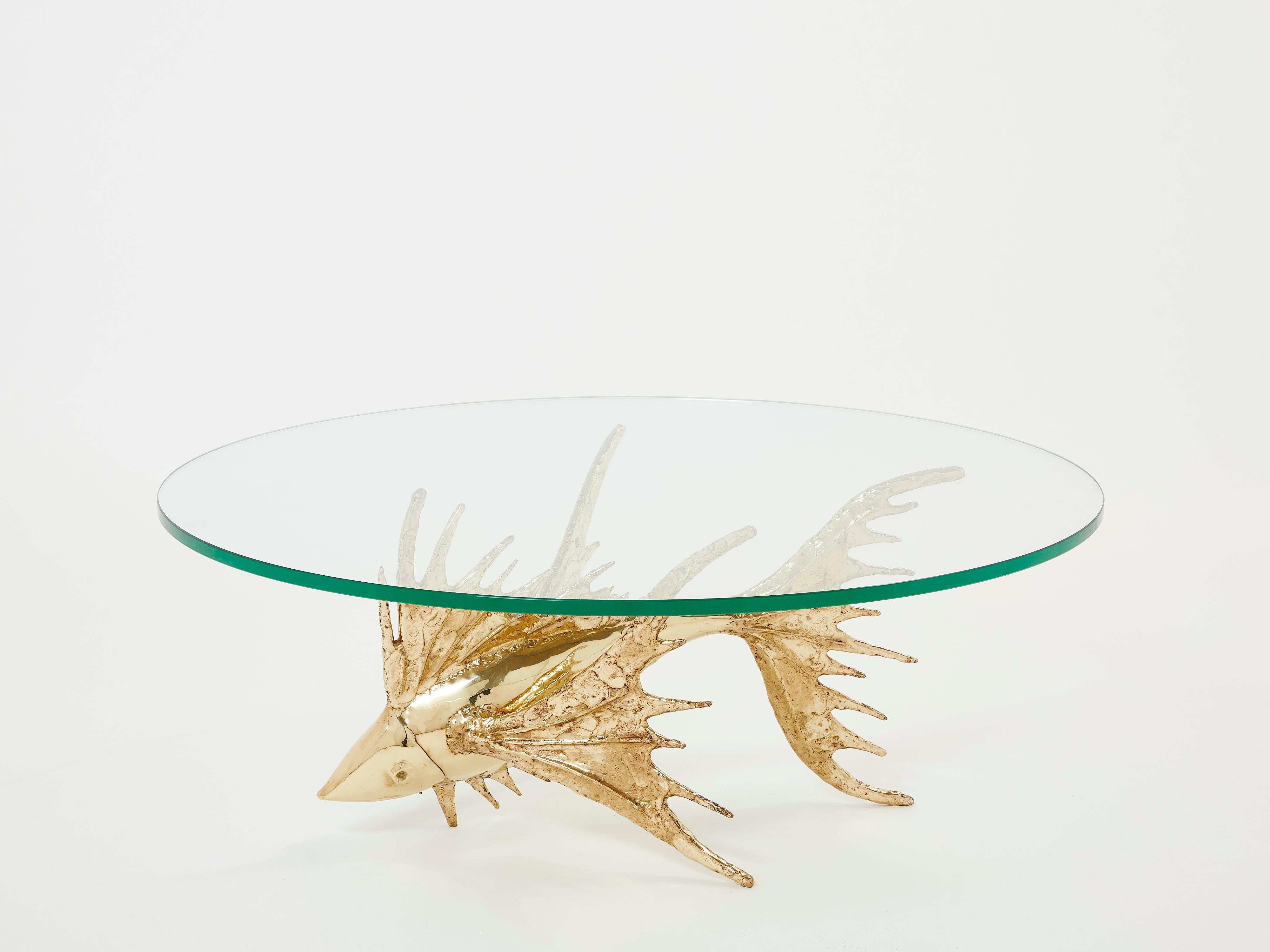 This unique fish sculpture coffee table signed by Alain Chervet is made of solid gilded brass, and dated 1977. It features a round thick glass top. This sculptural piece of furniture is truly one of a kind. The rich patinated brass textures are