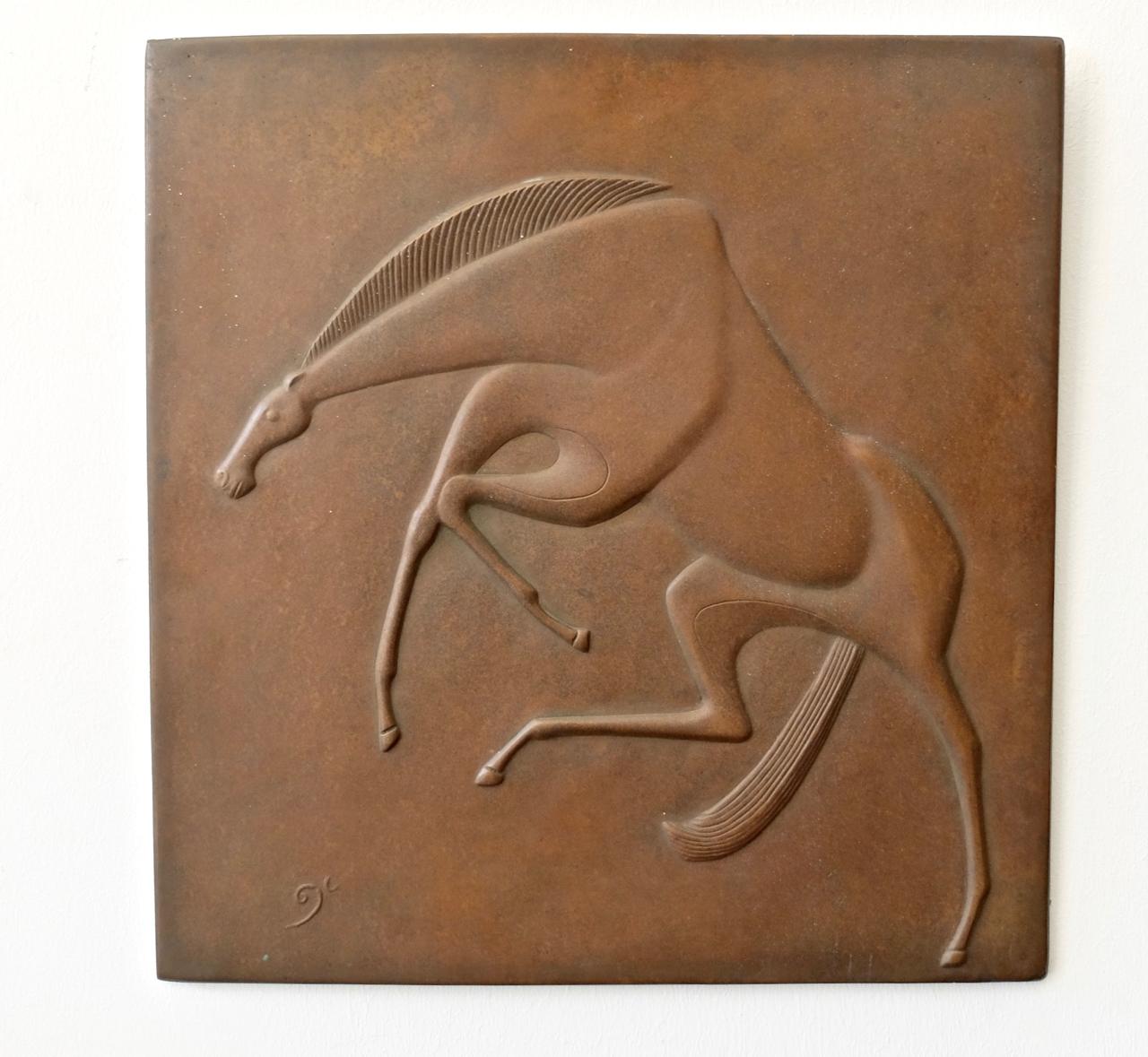 Artist : GERTRUD KORTENBACH 1924 Solingen - 1960 Solingen
Title: 'Jumping Horse' signed with monogram on front 
Material: Bronze, brown patina. Part. with traces of oxidation.
Measurements: H. 36 cm, W. 34 cm, D. 1 cm. 

GERTRUD KORTENBACH was a