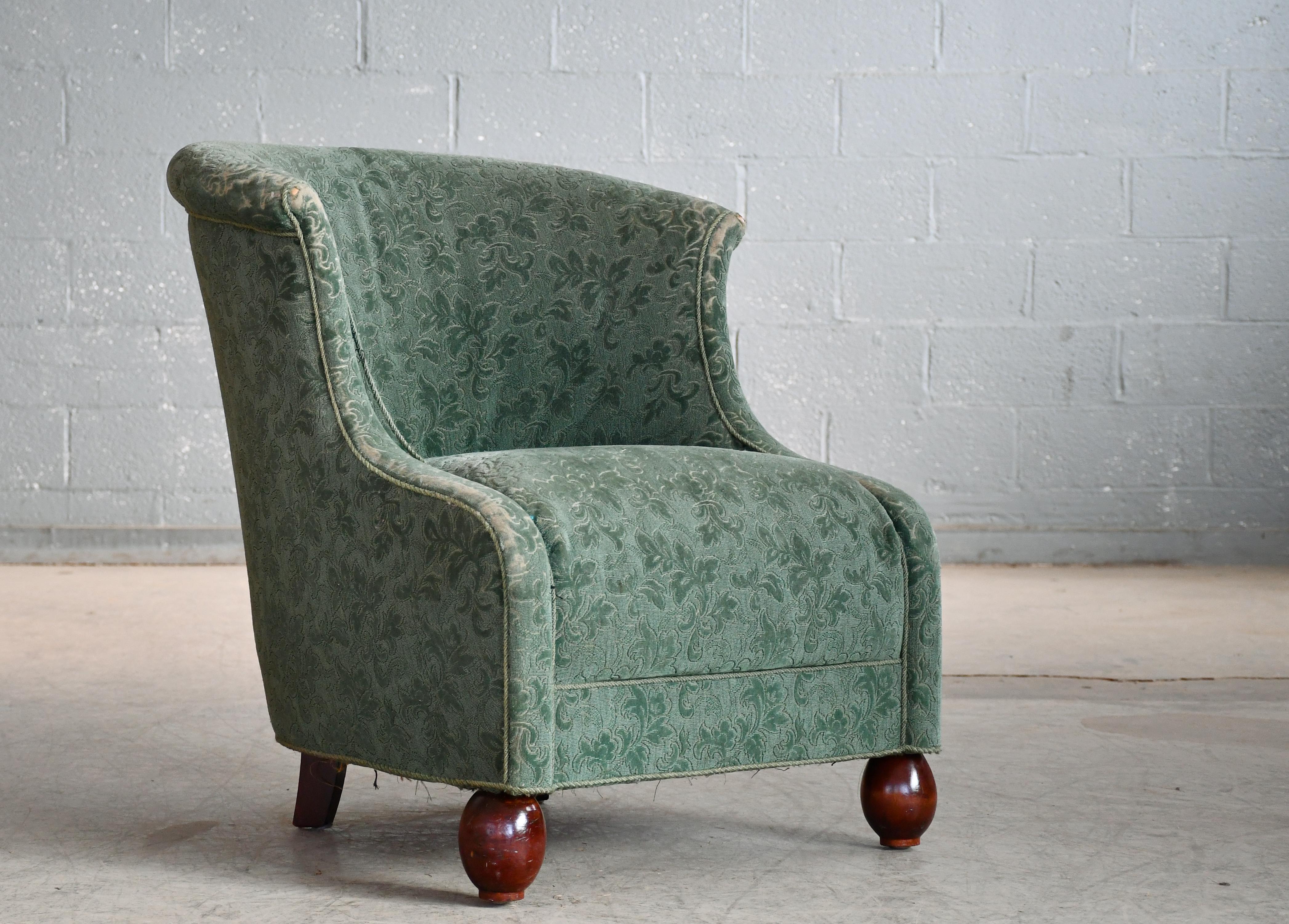 Fantastic 1930s-1940s lounge chair from the late Art Deco early midcentury era. Strong statement piece for any room despite modest proportions.  Super charming. raised on mahogany legs and with coil springs in the seat and backrest. Overall very