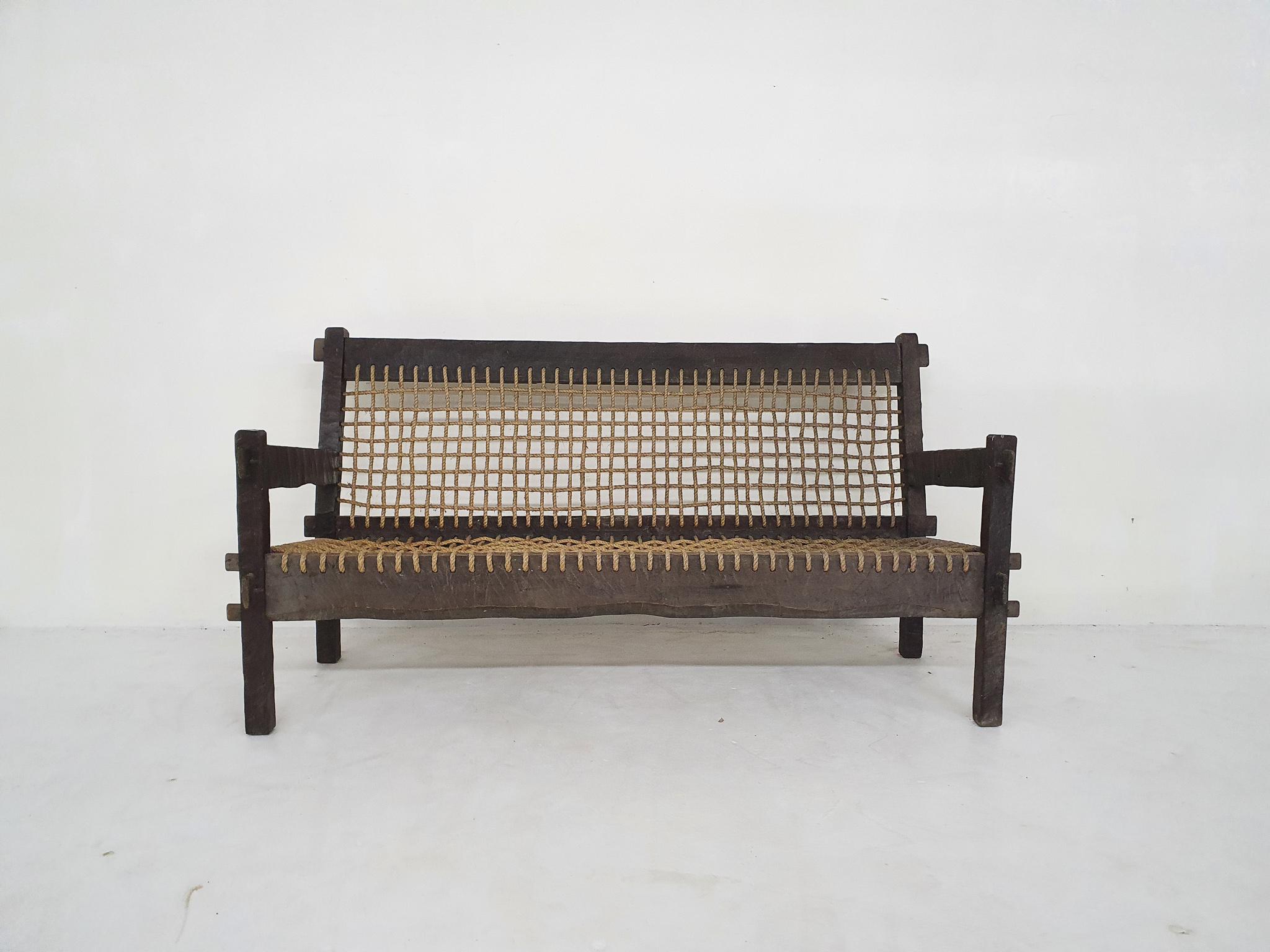 Schönes handgeschnitztes Holzsofa mit Sitzfläche und Rückenlehne aus Seil.
