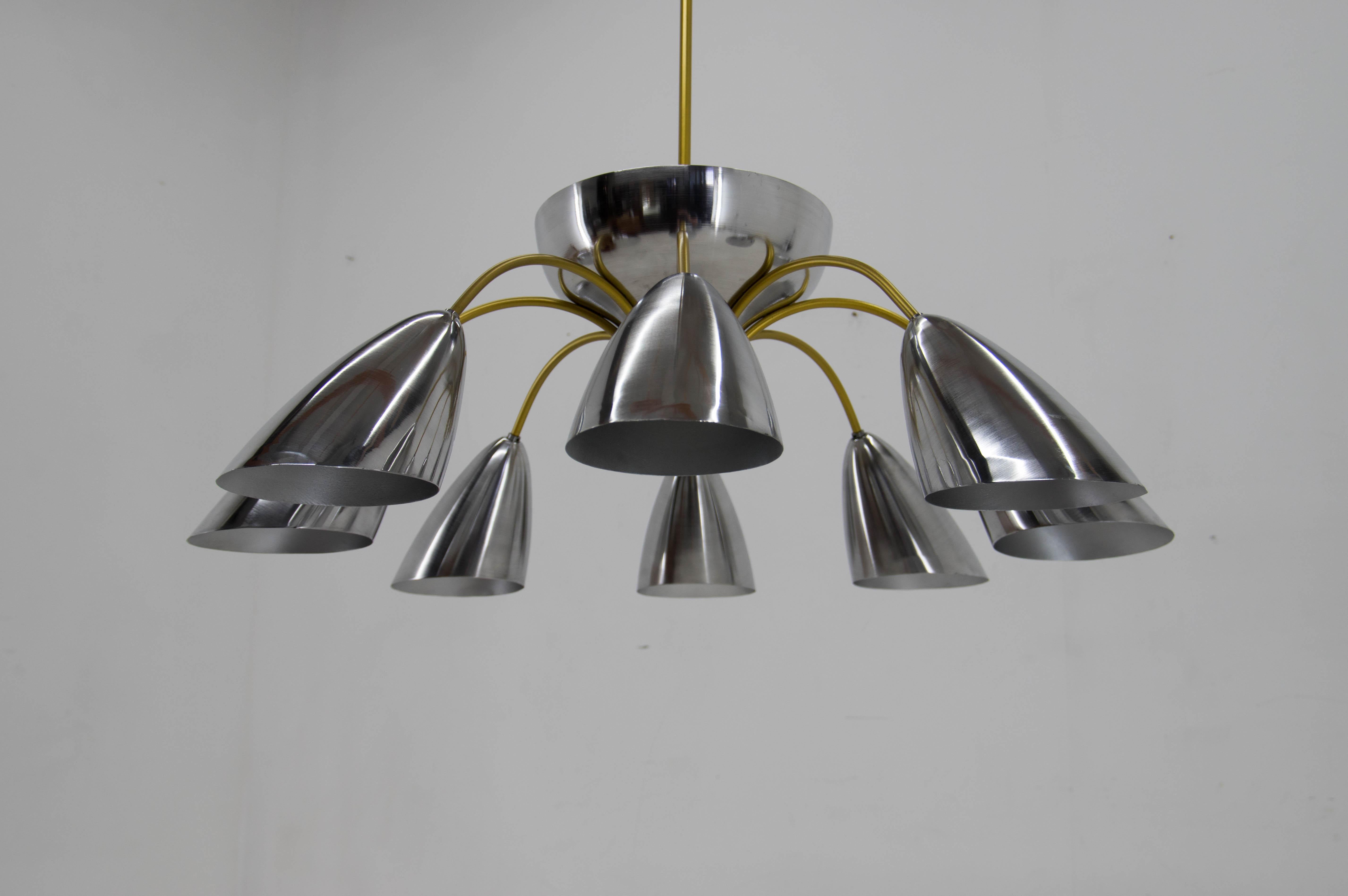 Extraordinary Space Age chandelier custom made in 1960s. Only few pieces were made for representative purposes in Czech factory. This piece was carefully disassembled, cleaned, the steel arms repainted to the original brass color, aluminum shades