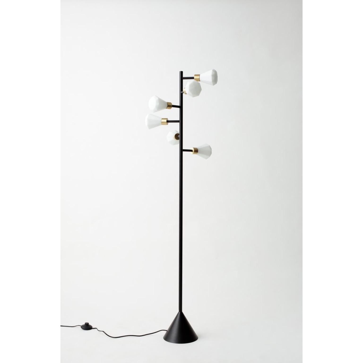Unique spiral floor lamp by Hatsu.
Dimensions: W 36 x H 149 cm. 
Materials: opal glass with powdercoated aluminium, brass details.

Hatsu is a design studio based in Mumbai that creates modern lighting that are unique and immediately