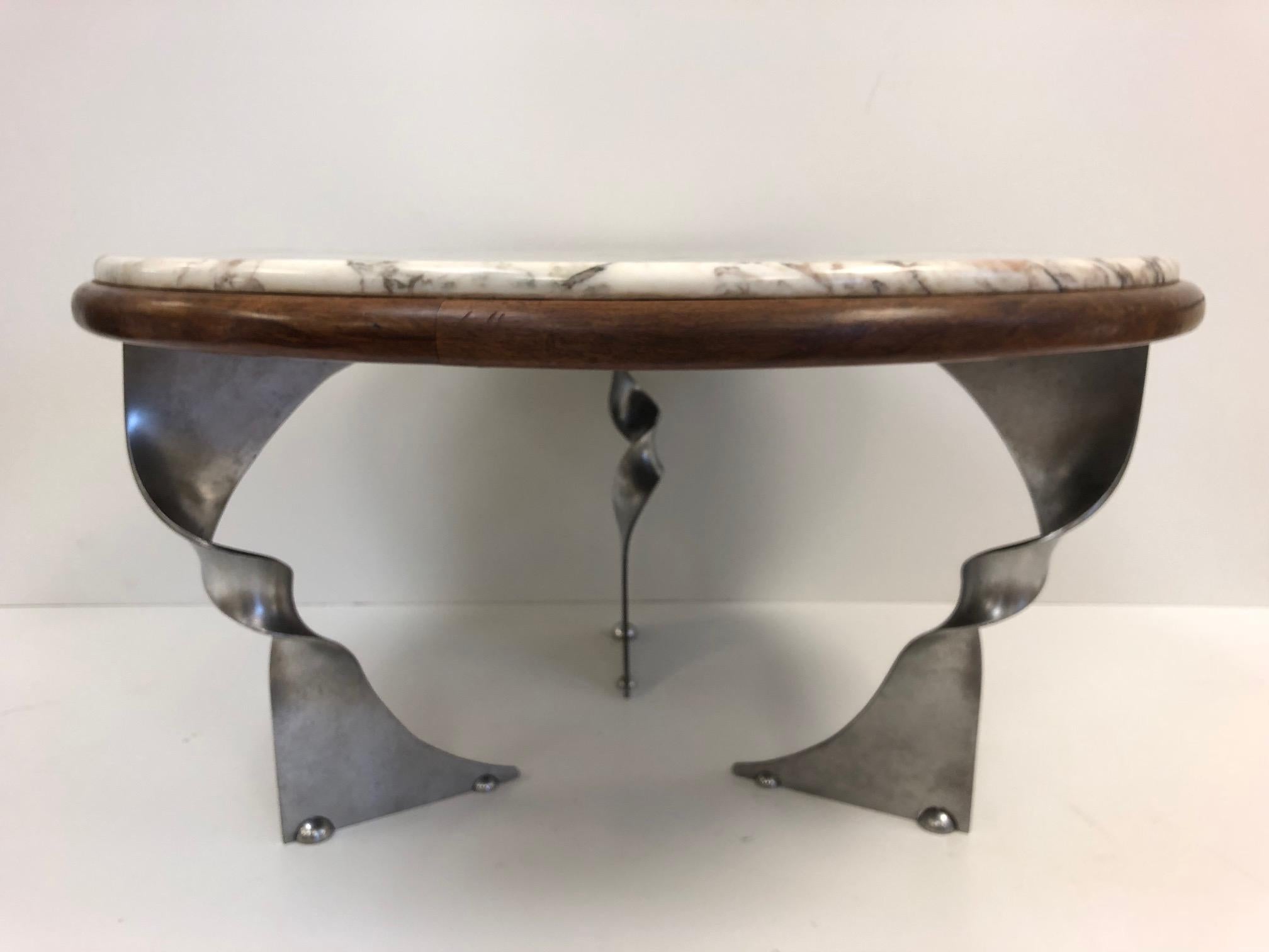 Unique steel base and marble-top coffee table. Table has a solid walnut trim. Marble in great condition. Marble is attached.