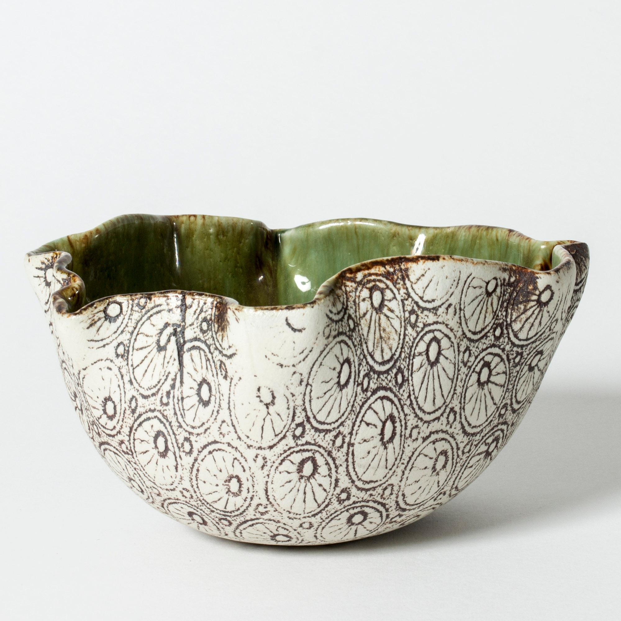 Unique stoneware bowl by Bengt Berglund, in an organic form with an undulating edge. Beautiful blue and green glazed inside, unglazed outside with an embossed graphic pattern.