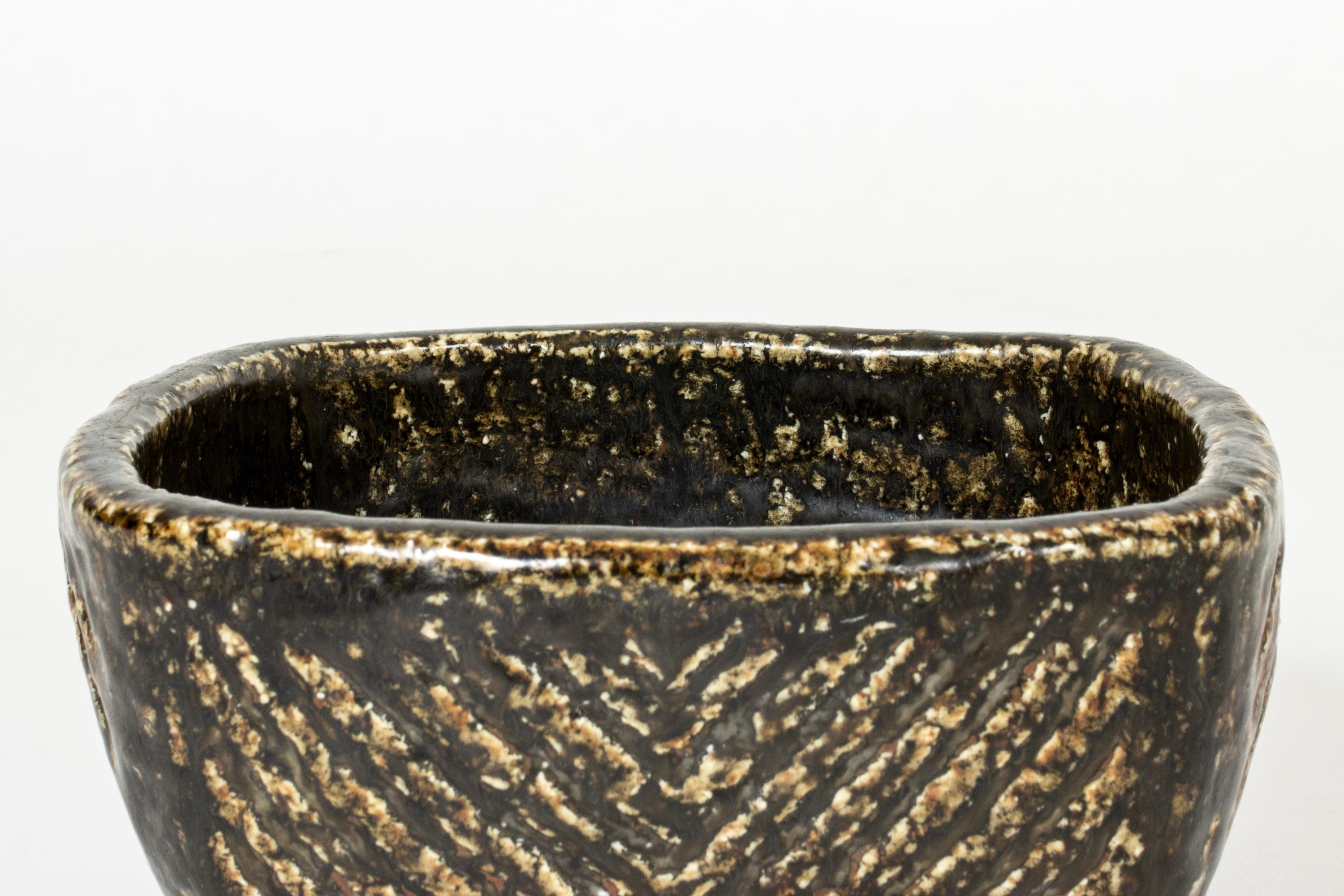 Unique chamotte bowl by Carl-Harry Stålhane, made in a heavyset design with dark, thick glaze, typical of his 1960s production. Bark-like effect.

Carl-Harry Stålhane was one of the stars among Swedish ceramic artists during the 1950s, 1960s and