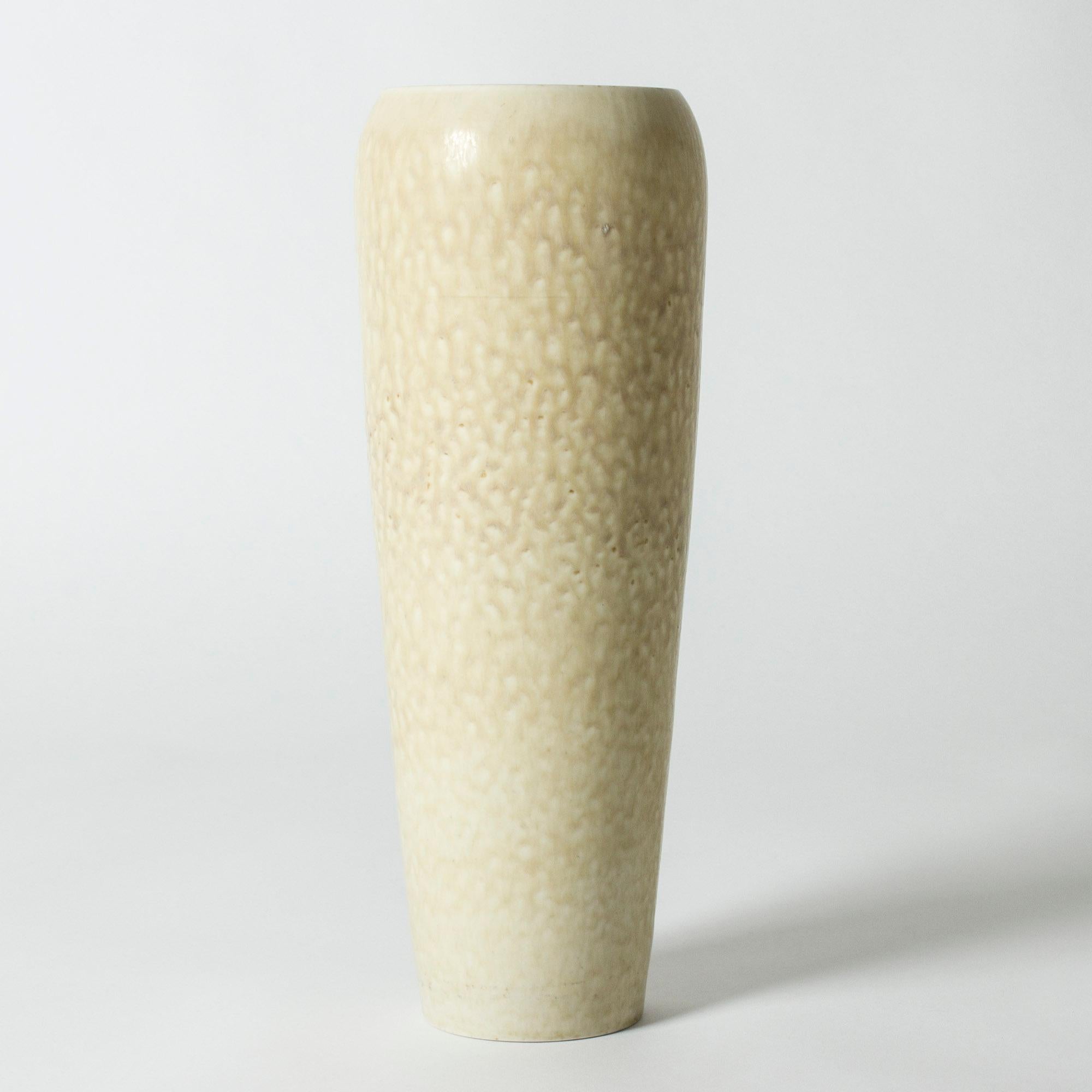 Beautiful, unique stoneware floor vase by Carl-Harry Stålhane. Tapering form with a wide mouth. Cream colored glaze with an organic patterned structure.

Carl-Harry Stålhane was one of the stars among Swedish ceramic artists during the 1950s,