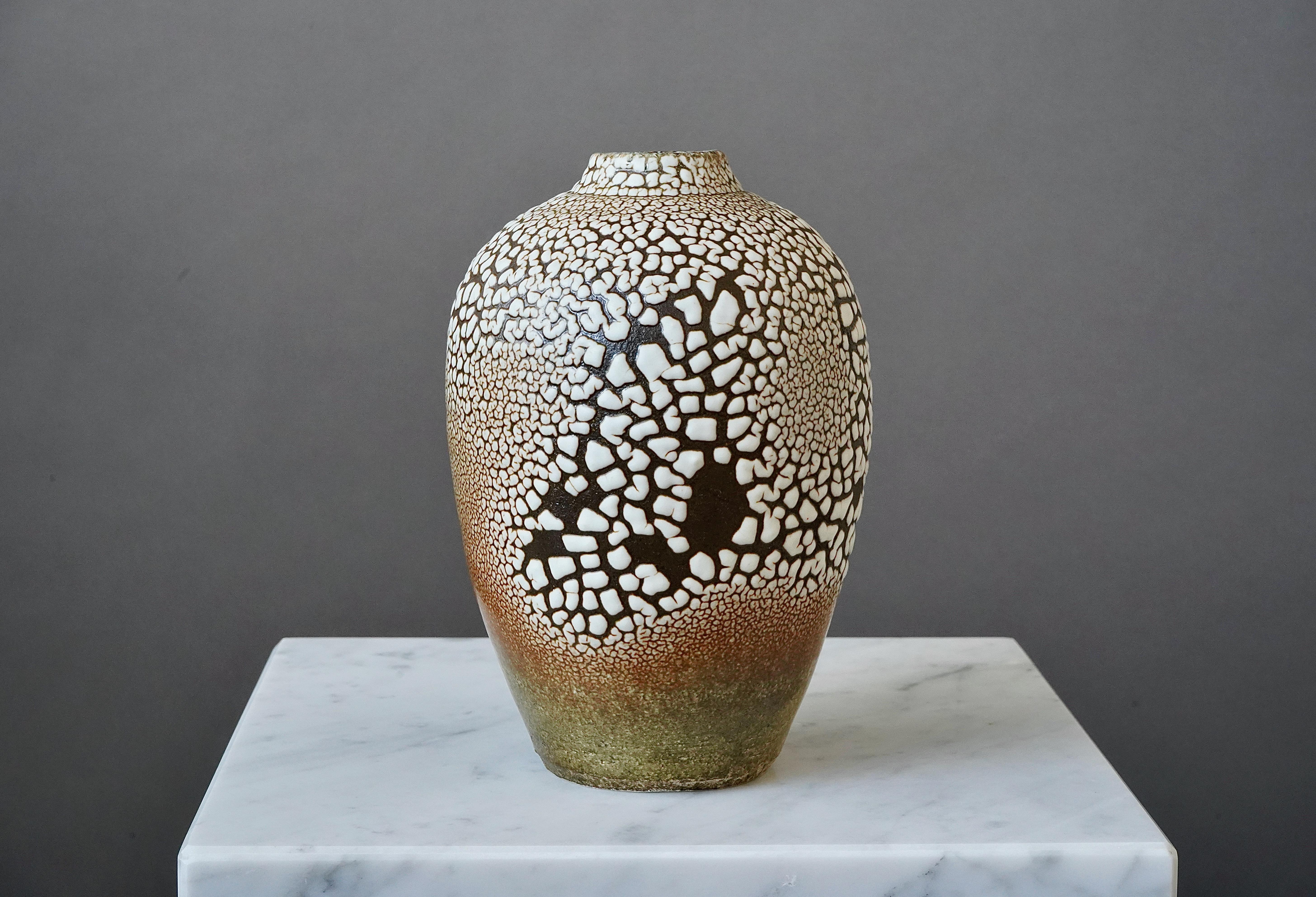 A beautiful and unique stoneware vase with amazing glaze. 
Made by Swedish ceramist Rune Bergman in his studio in Simrishamn, Sweden.

Excellent condition. Signed 'RB'.
