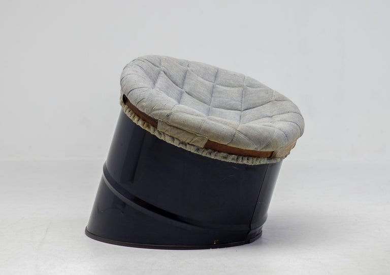 Impossible to find avant garde piece by Studio Simon, Italy. 
A dark blue steel oil drum cut diagonally and upholstered with a foam filled seat that is attached to the drum by a leather belt. In all original unrestored condition.
Marked at the
