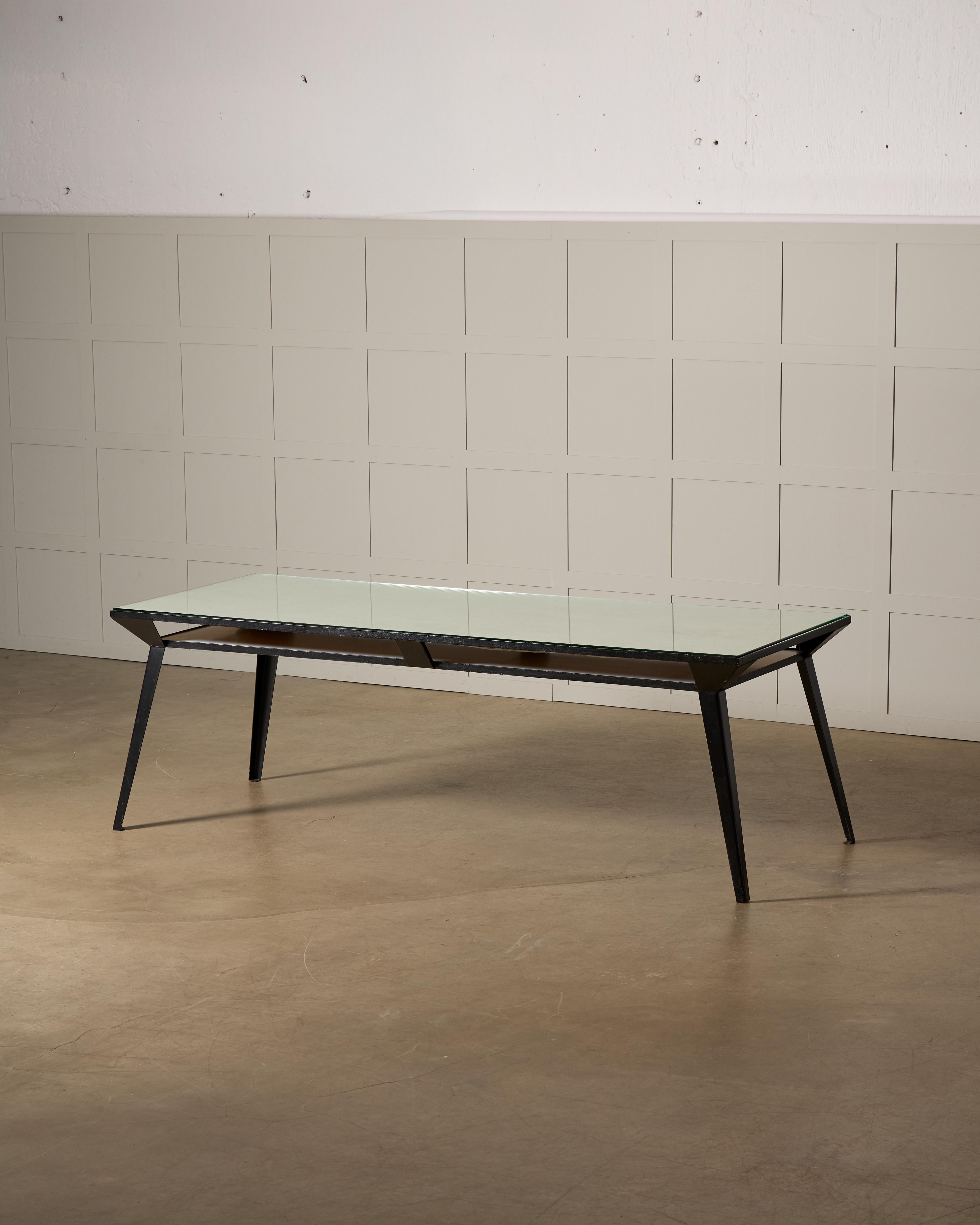 This exceptional one-of-a-kind dining table, crafted in Sweden during the 1950s, is a striking fusion of industrial elegance and innovative design. The table features a steel base with a bold, architectural structure reminiscent of the iconic design