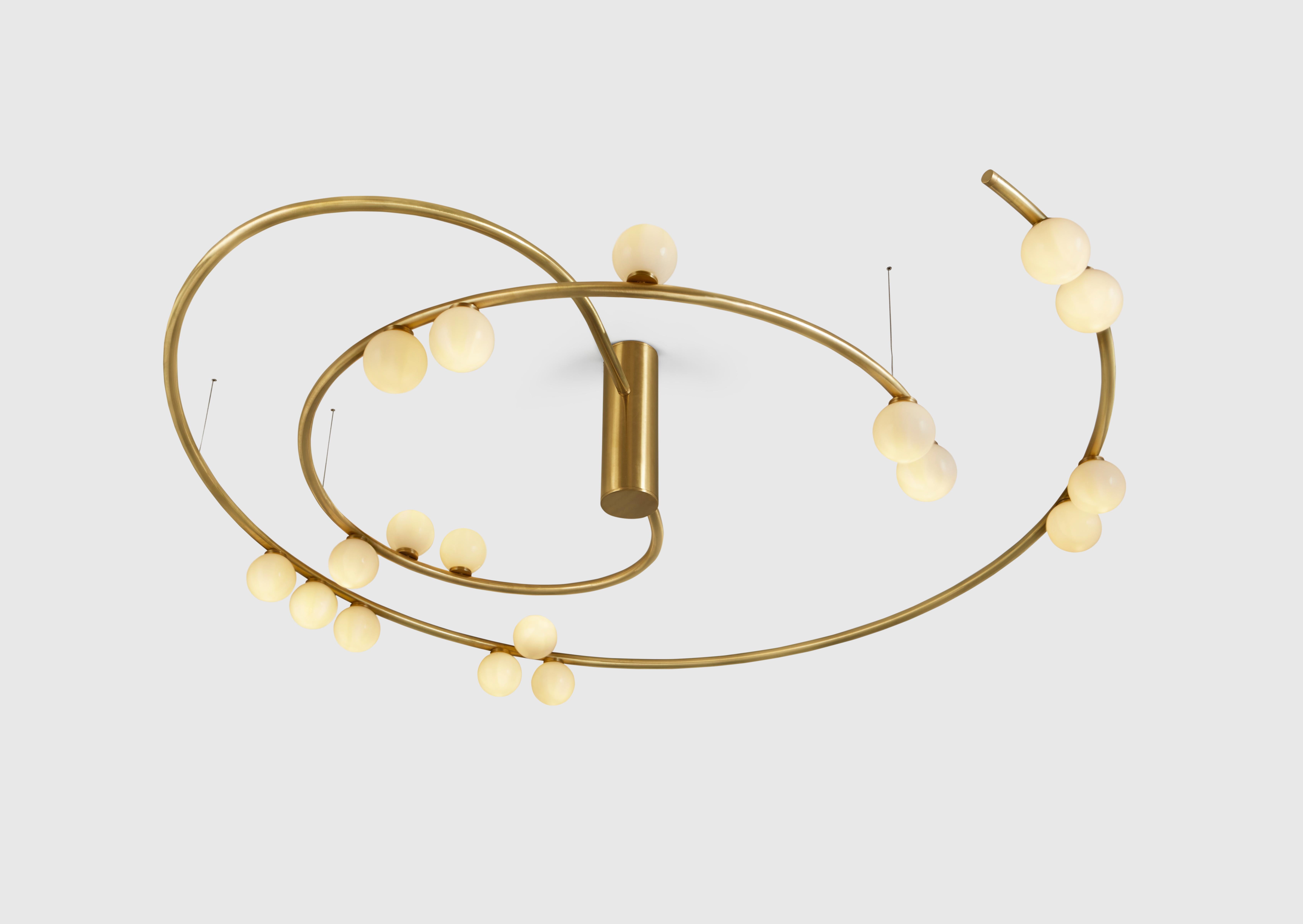 Unique swirl chandelier by Hatsu
Dimensions: D 130 x W 123 x H 20.32 cm 
Materials: Brass, glass

Hatsu is a design studio based in Mumbai that creates modern lighting that are unique and immediately recognisable. We started with an idea to make