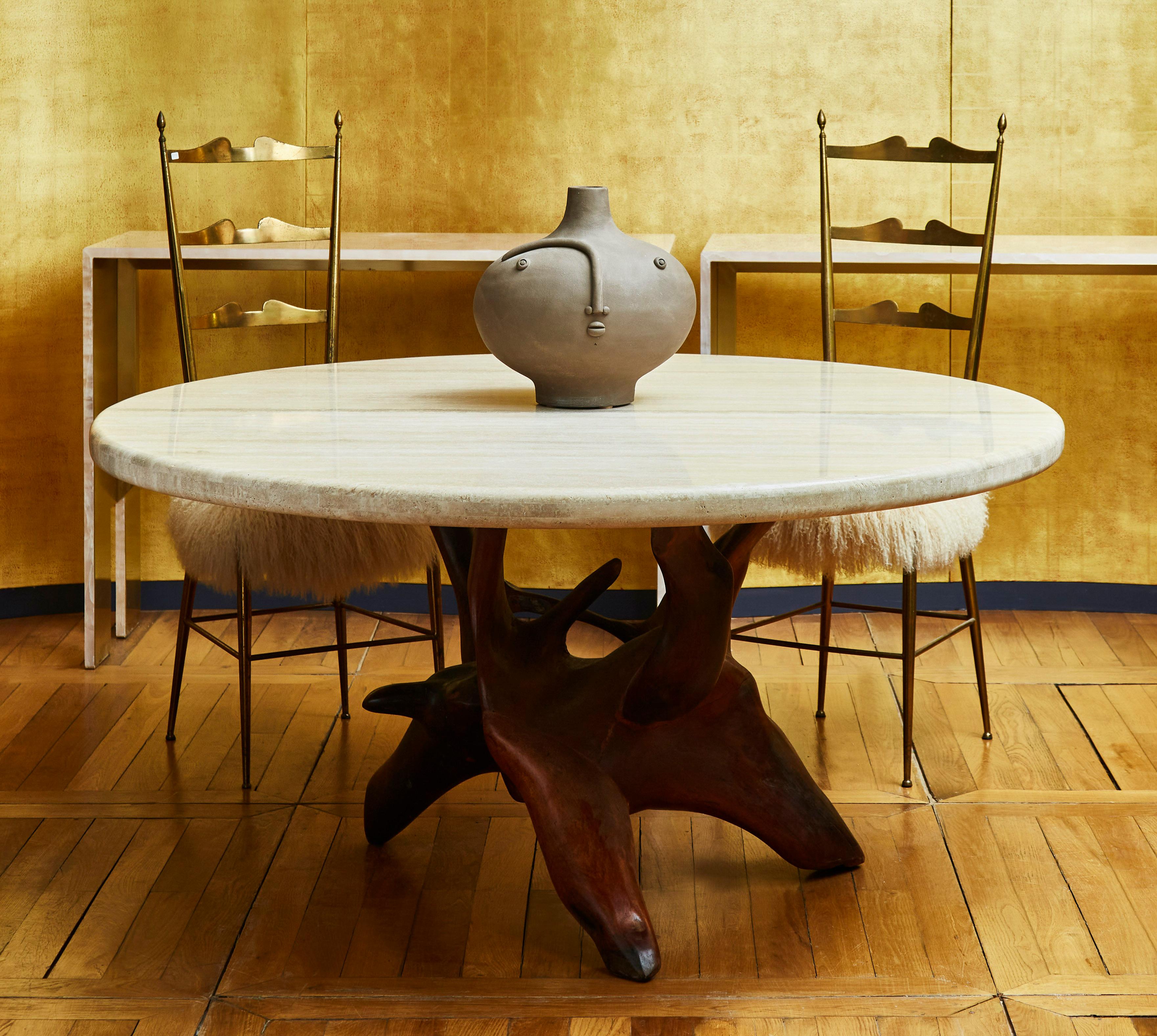 Amazing round table with a vintage sculpture base in wood from Brazil and a travertine stone top, especially made for the base, by Studio Glustin.
Unique piece. 
France.