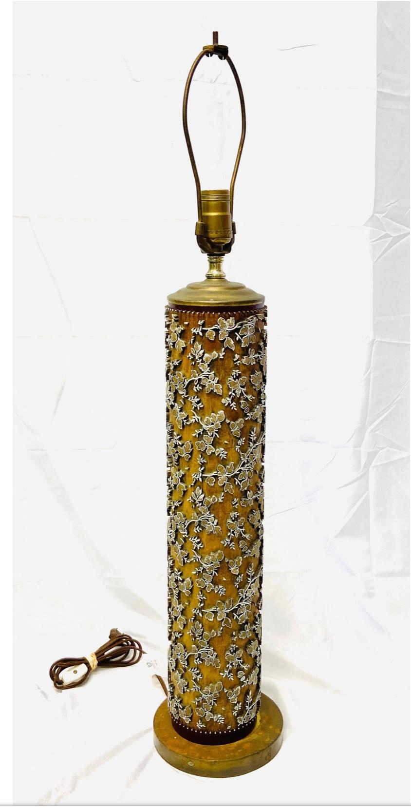 Unique wooden vintage printing roll table lamp. Made from vintage wallpaper printing roll. Brown in color with small swirling leaf motif. In the original finish and in working order. Metal base. No shades.