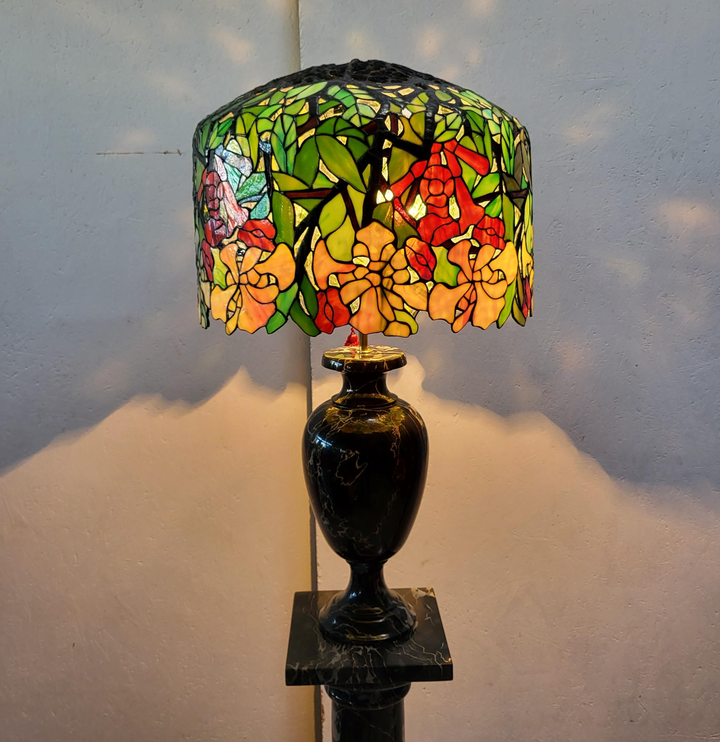 Stunning and amazing lamp in the manner of Tiffany Studios. 
Very impressive handmade lamp with a wonderful Breccia marble base.
 
Very fine handwork, colourful glass.

The lamp has an amazing warm light and is a wonderful art object.
It comes in a