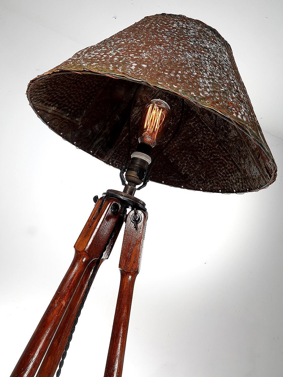 This floor lamp was assembled using a beautiful antique tripod. The tripod is well over 100 years old and still retains the beautiful patina. The shade was made using a piece of early pressed tin ceiling that still shows some original paint and