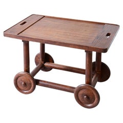 Unique trolley in oak with tray top and large wheels.