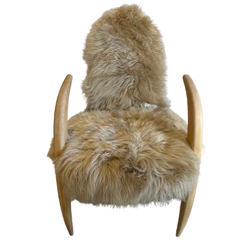 Very Unique pair of Accent chairs
Featuring Tusk-Like arms of solid wood
Newly upholstered in mushroom tone sheepskin & soft velvety neutral tone fabric on the backs
Comfortable to sit in & also great Accent chairs.
 